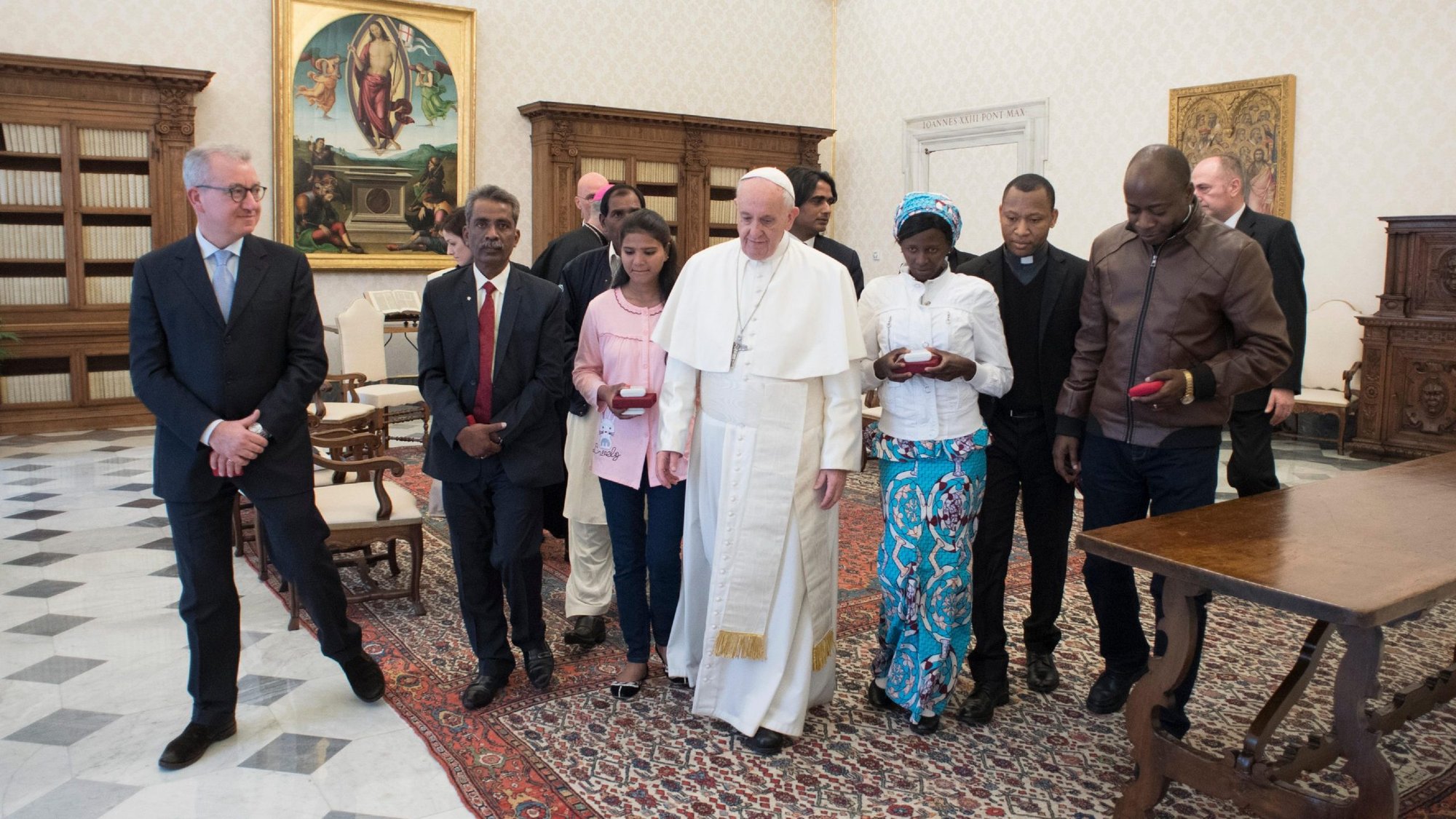 In this 2018 file photo, Pope Francis walks with family members of Asia Bibi, a Christian woman sentenced to death in Pakistan, during a private audience at the Vatican."My heart broke when I had to leave without saying goodbye to my father or other members of the family," Bibi said in a new autobiography. (CNS photo/Vatican Media)