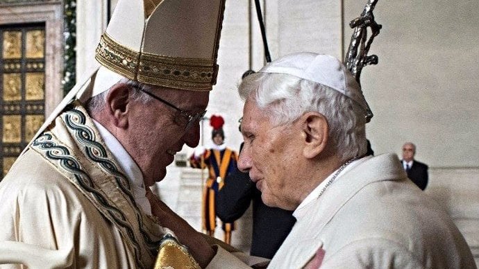 Pope Francis greeted retired Pope Benedict XVI before opening the Holy Door in St. Peter's Basilica at the Vatican Dec. 8, 2015. (CNS/L'Osservatore Romano, handout/EPA via Crux)