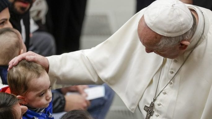 Pope Francis caresses a baby during his weekly general audience in the Pope Paul VI hall at the Vatican, Wednesday, Feb. 5, 2020. (Andrew Medichini/AP via Crux)