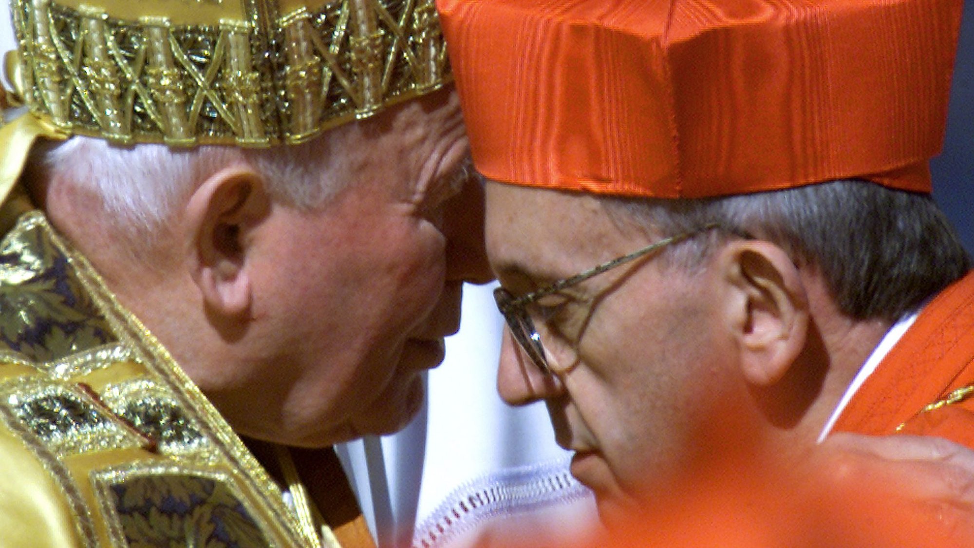 Pope John Paul II embraces Argentine Cardinal Jorge Bergoglio after presenting the new cardinal with a red beretta at the Vatican Feb. 21, 2001. (CNS photo/Reuters)