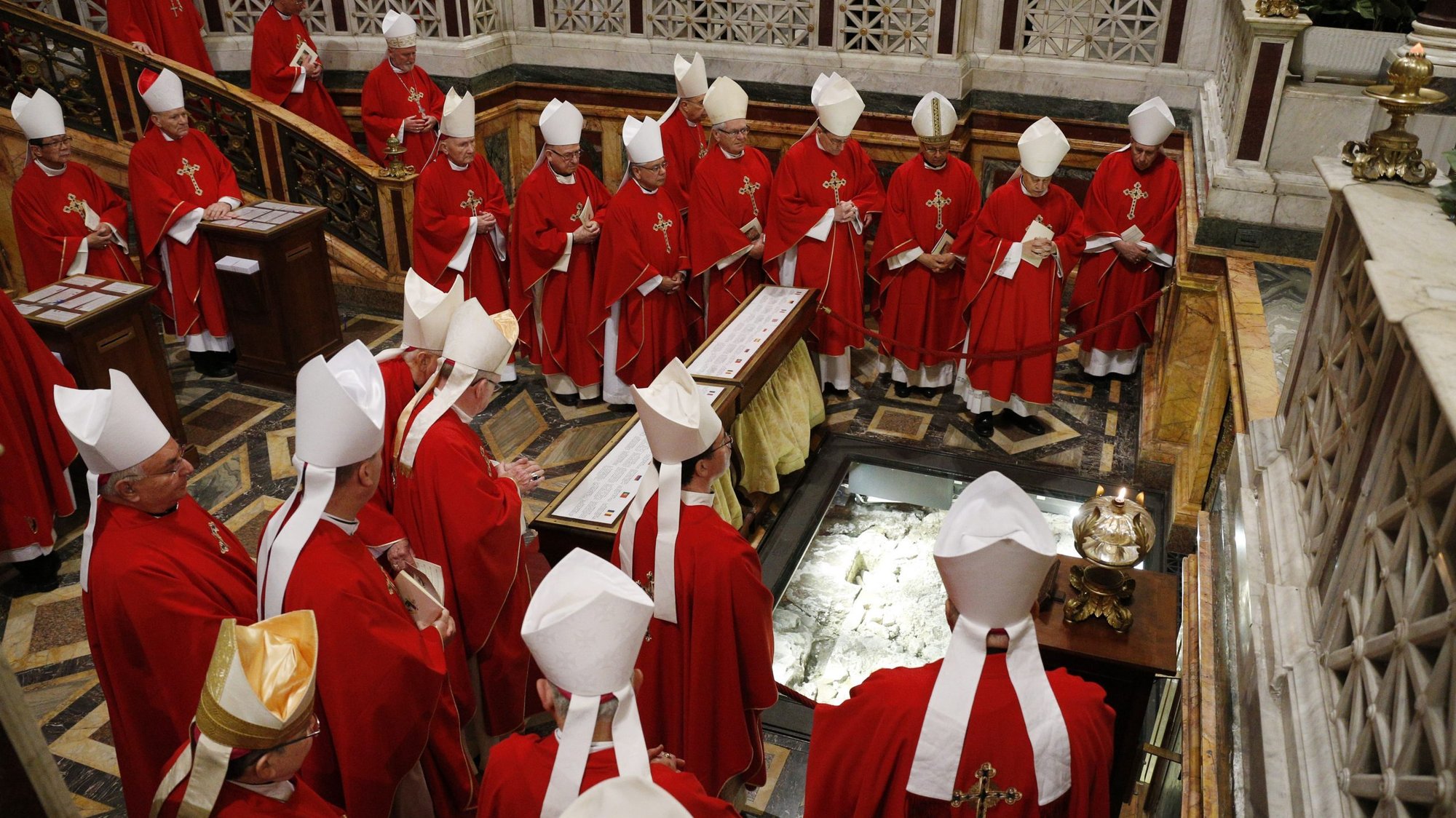 Bishops from California, Hawaii and Nevada pray at the tomb of St. Paul after concelebrating Mass at the Basilica of St. Paul Outside the Walls while making their "ad limina" visits in Rome Jan. 31, 2020.