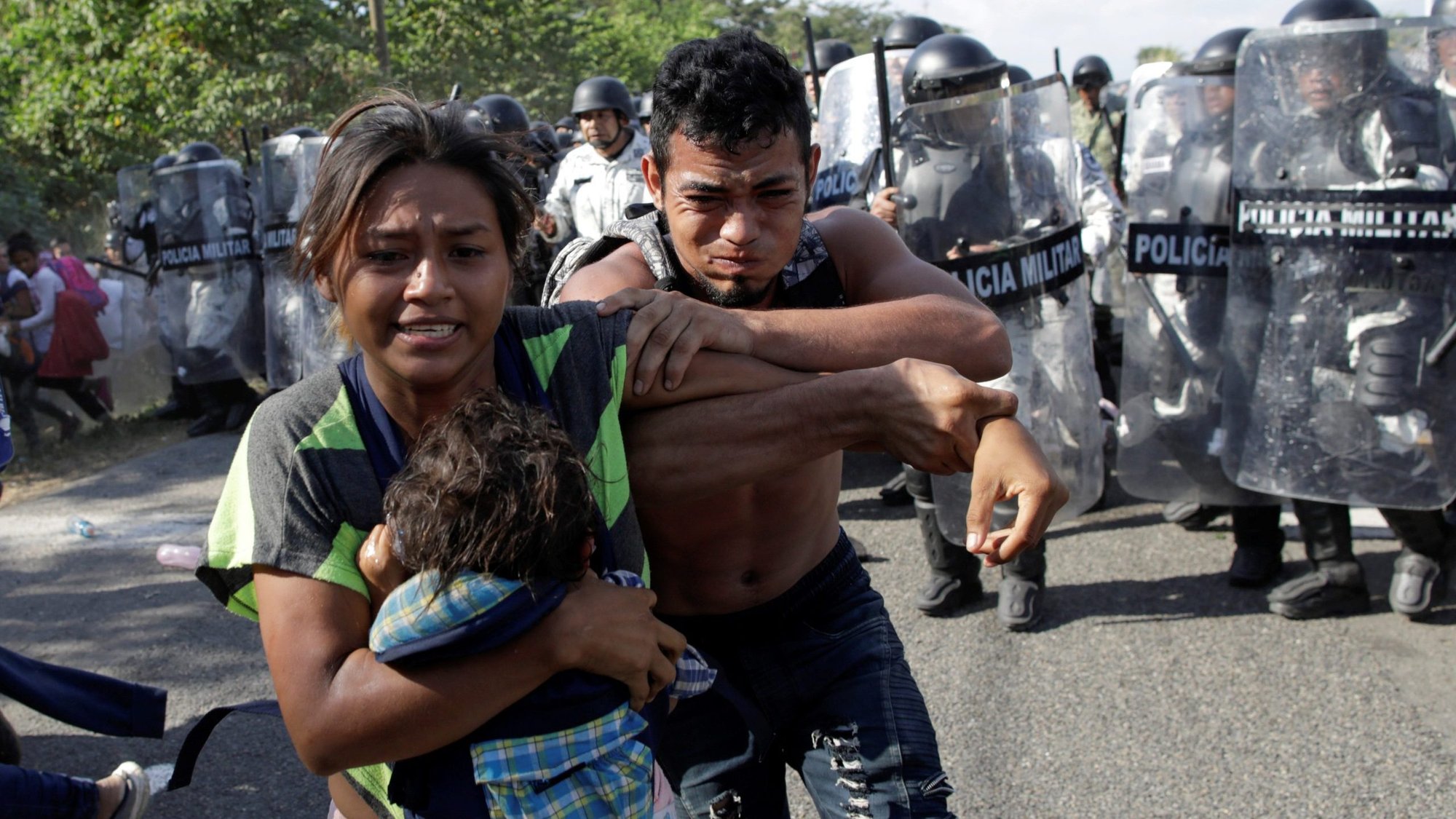 Migrants from Central America trying to reach the United States react as police approach them near Frontera Hidalgo, Mexico, Jan. 21, 2020. At least 138 Salvadorans have been murdered after being deported back to country from the United States, according to a report released Feb. 5 from Human Rights Watch. (CNS photo/Andres Martinez Casares, Reuters)