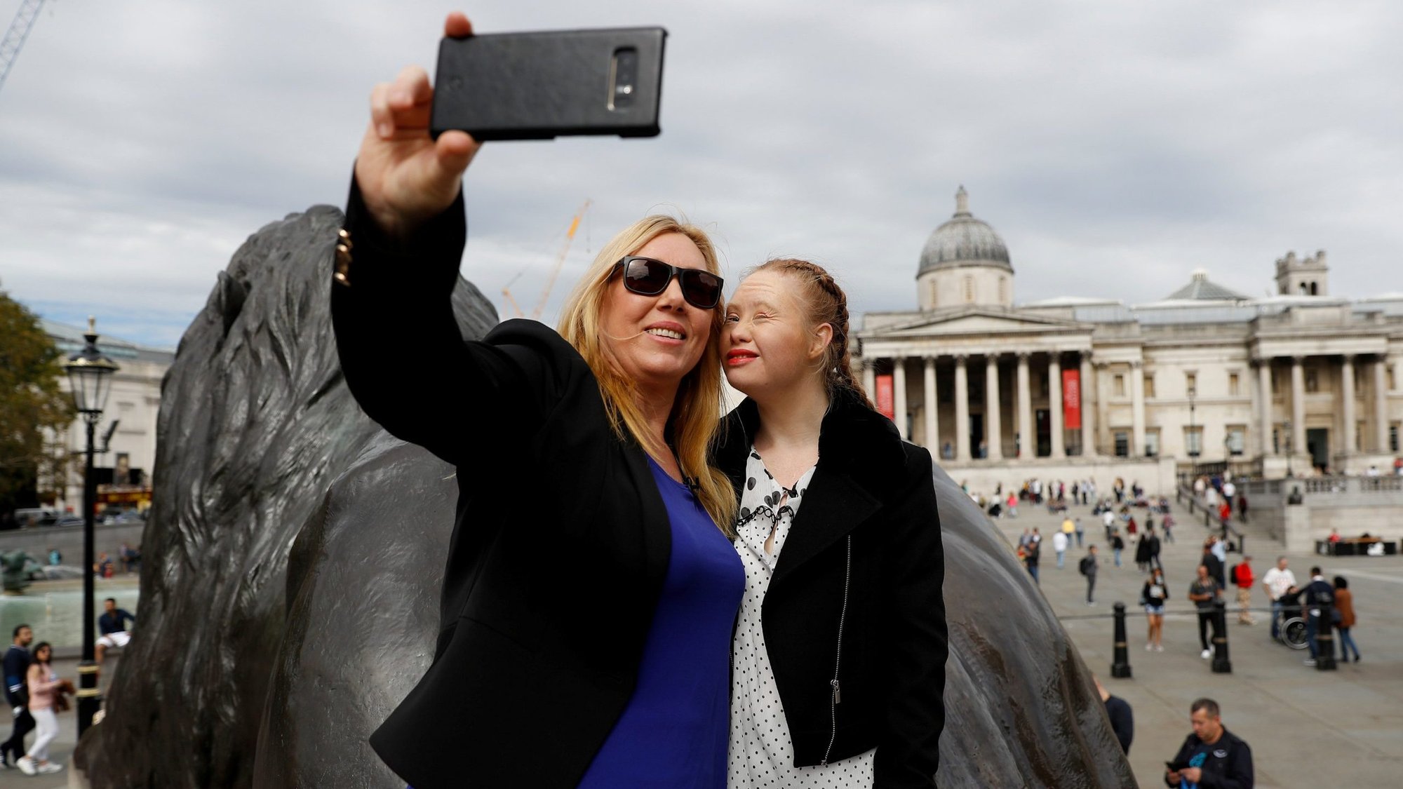 Australian model Madeline Stuart, who has Down syndrome, poses for photographs with her mother, Rosanne, while sightseeing in Trafalgar Square in London Sept.16, 2018. Heide Crowter, 24, of central England, will take the British government to court in an attempt to change a law that permits abortions up to birth of children considered to be "seriously handicapped." (CNS photo/Peter Nicholls, Reuters)