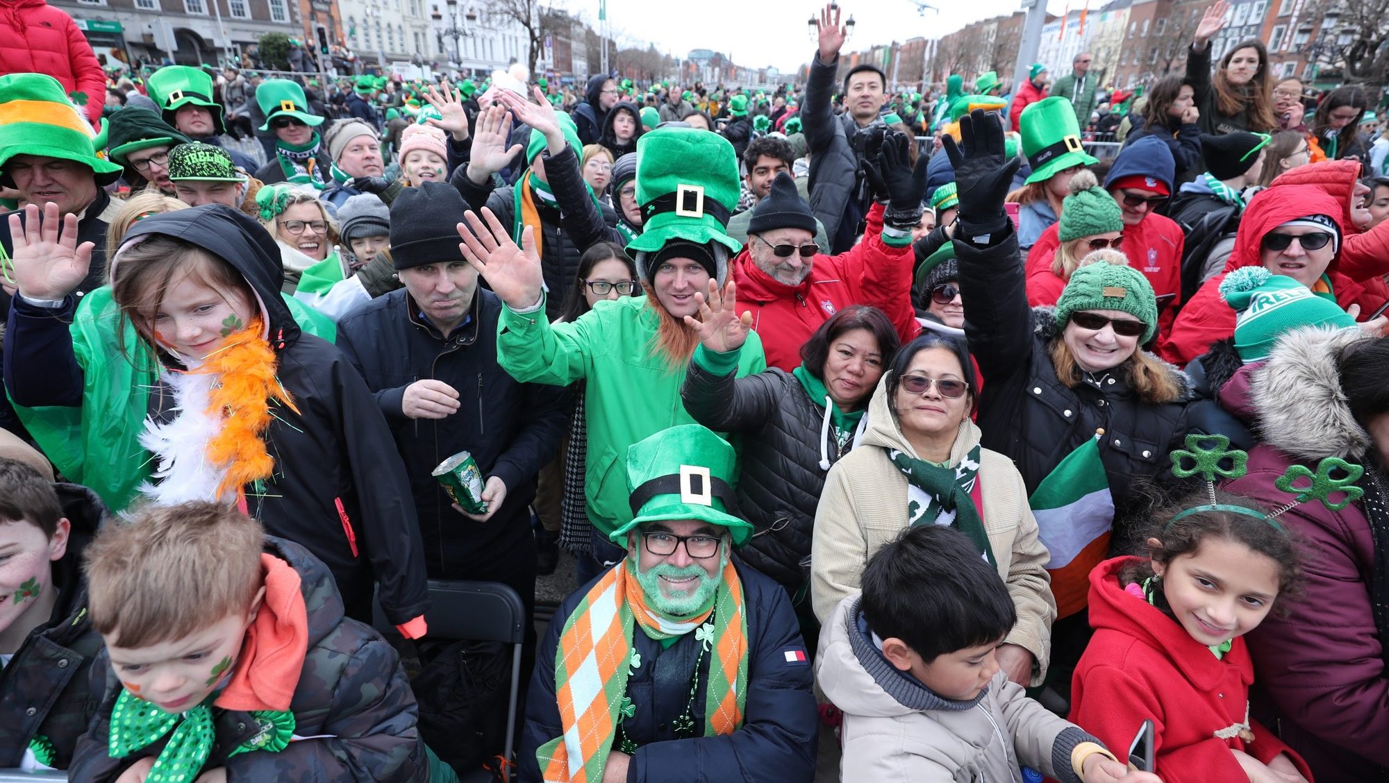 People wave as they watch the St. Patrick's Day Parade in Dublin March 17, 2019. Dublin's iconic parade has been canceled in 2020 due to fears over the spread of coronavirus. (CNS photo/Niall Carson, Reuters)