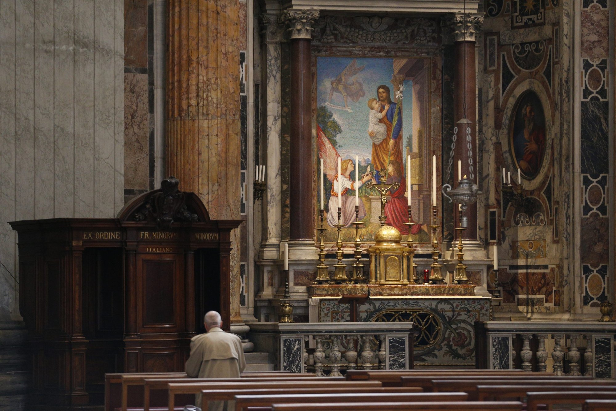 A man prays in St. Peter's Basilica at the Vatican after the closure of the basilica to tourists March 10, 2020. The Vatican has closed St. Peter's Square and Basilica to tourists March 10 through April 3 in cooperation with Italian emergency procedures aimed at preventing the spread of the coronavirus. (CNS photo/Paul Haring)