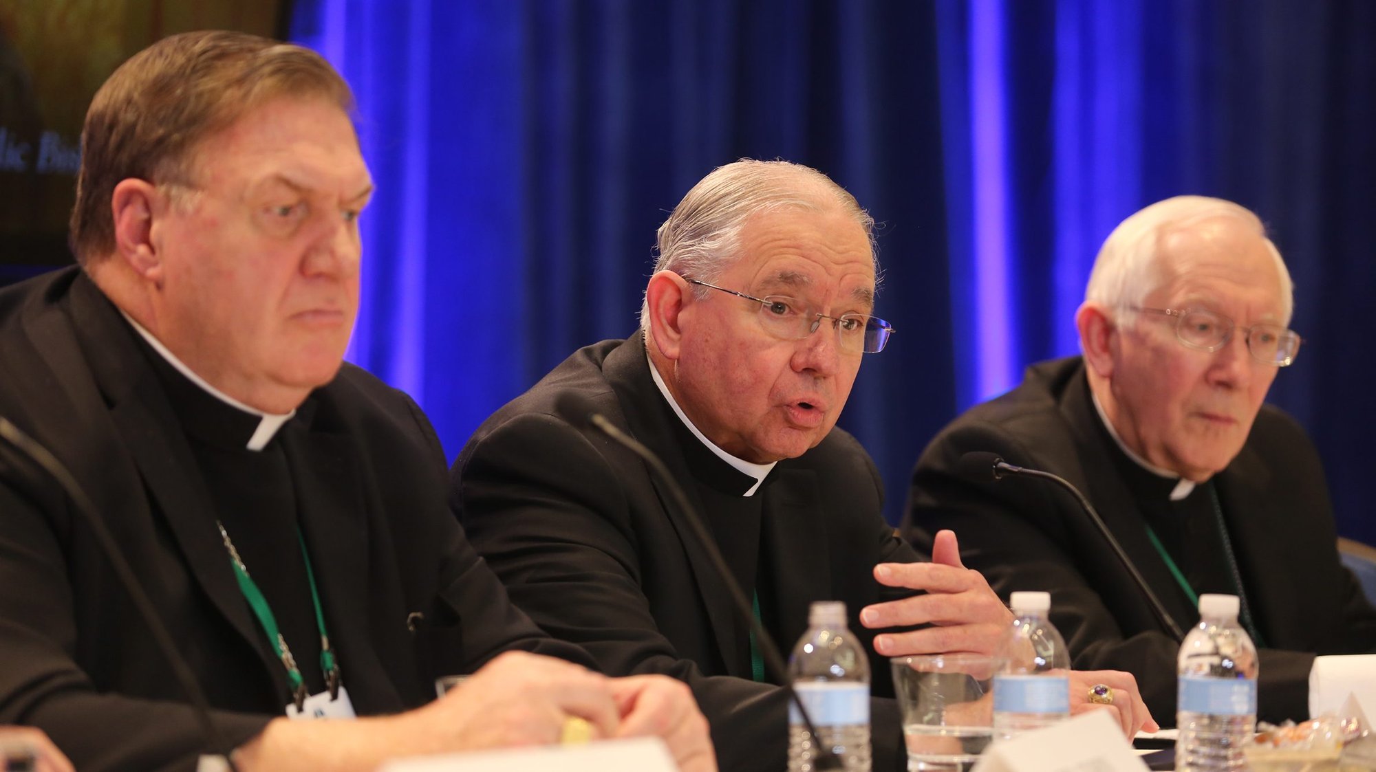 Archbishop Jose H. Gomez of Los Angeles, president of the U.S. Conference of Catholic Bishops, responds to a question during a news conference at the fall general assembly of the USCCB in Baltimore Nov. 12, 2019. Also pictured are: Cardinal Joseph W. Tobin of Newark, N.J., and Archbishop Leonard P. Blair of Hartford, Conn. The third-party reporting system to record abuse complaints against bishops, approved in November, has officially begun. (CNS photo/Bob Roller)
