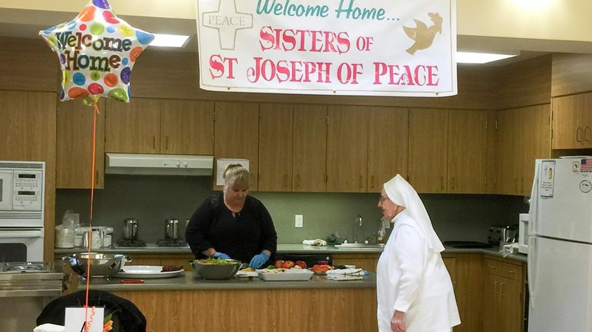 Sister Cabrini Delaney consults with a member of the dietary staff at the Sisters of St. Joseph of Peace's Englewood Cliff, N.J., facility, in this October 2016 photo. Care for retired religious takes special emphasis amid the coronavirus pandemic. (CNS photo/courtesy Sisters of St. Joseph of Peace)