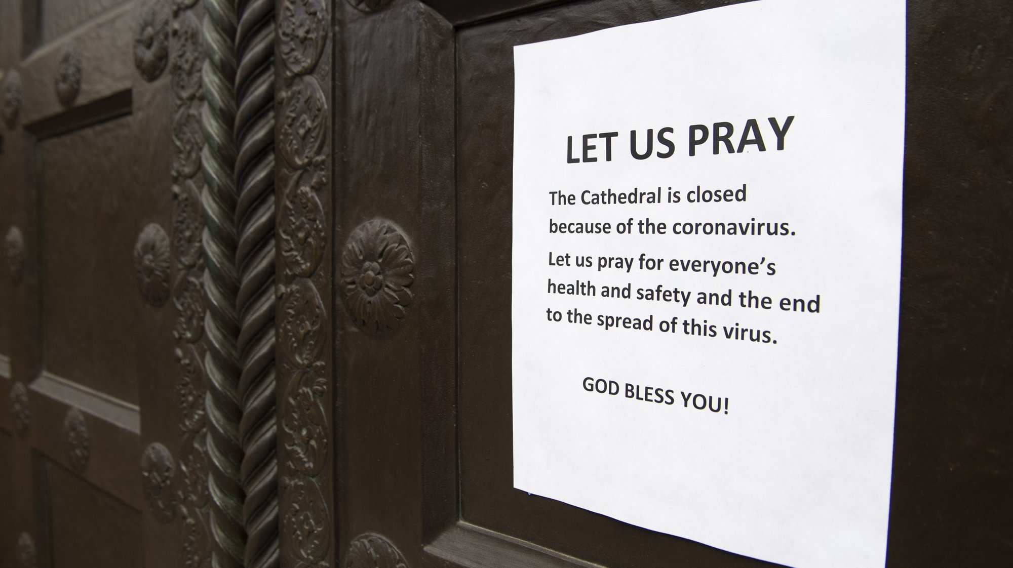 A sign announcing that the Cathedral of St. Matthew the Apostle in Washington is closed amid the coronavirus pandemic is seen on the church door March 18, 2020. (CNS photo/Tom Williams, CQ Roll Call, via Reuters)