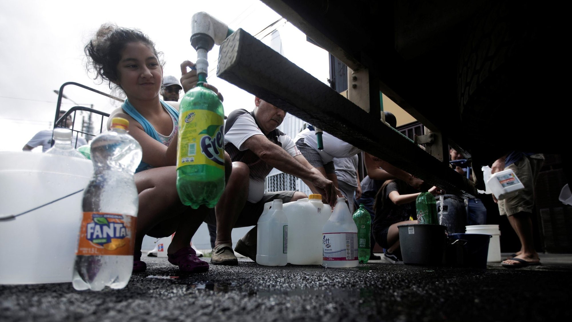People collect clean drinking water from a tanker sent by government authorities as part of measures to help prevent the spread of the coronavirus in San Jose, Costa Rica, March 14, 2020. The Vatican said defending the right to clean water is part of the Catholic Church's promotion of the common good. (CNS photo/Juan Carlos Ulate, Reuters)