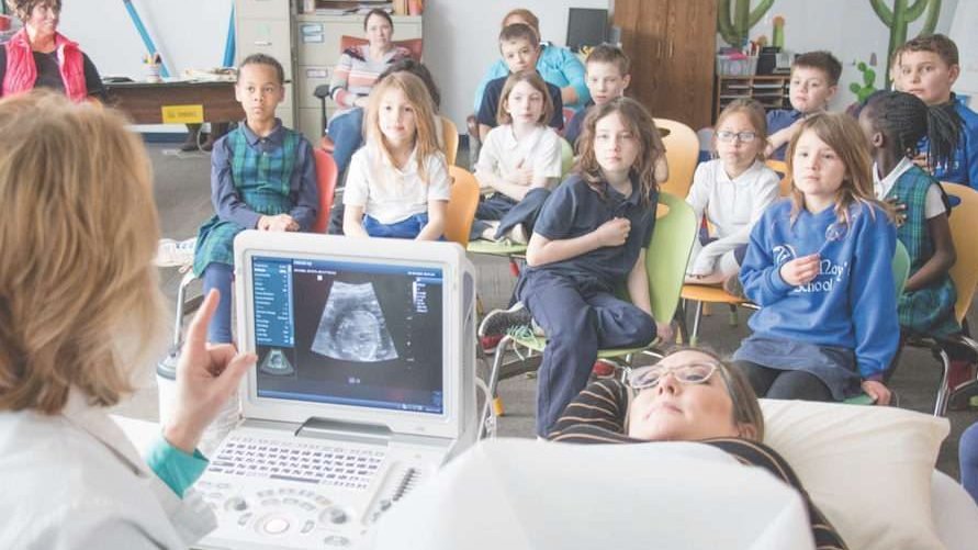 Second-graders at St. Mary School in Bellevue watch a live ultrasound presentation Feb. 28 showing the 21-week-old baby inside Kelly Miller. (Susan Szalewski/Catholic Voice via CNA)