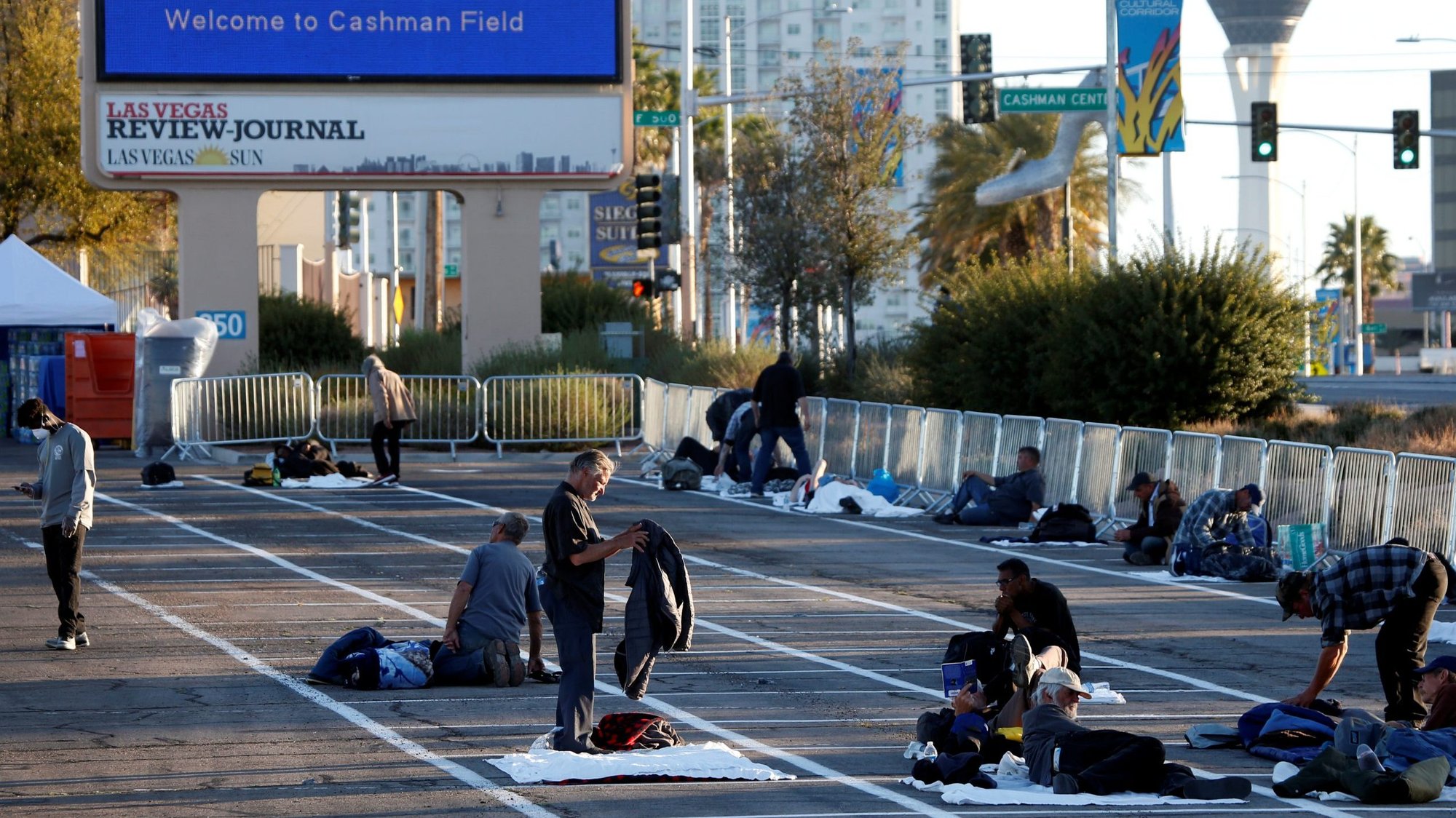 Homeless people get settled in a temporary parking lot shelter at the Cashman Center in Las Vegas March 30, 2020, with spaces marked for social distancing to help slow the spread of COVID-19. At the start of the April 2 Mass in the chapel at his Vatican residence, the Domus Sanctae Marthae, Pope Francis said he was struck by a similar photo in a local newspaper. (CNS photo/Steve Marcus, Reuters)
