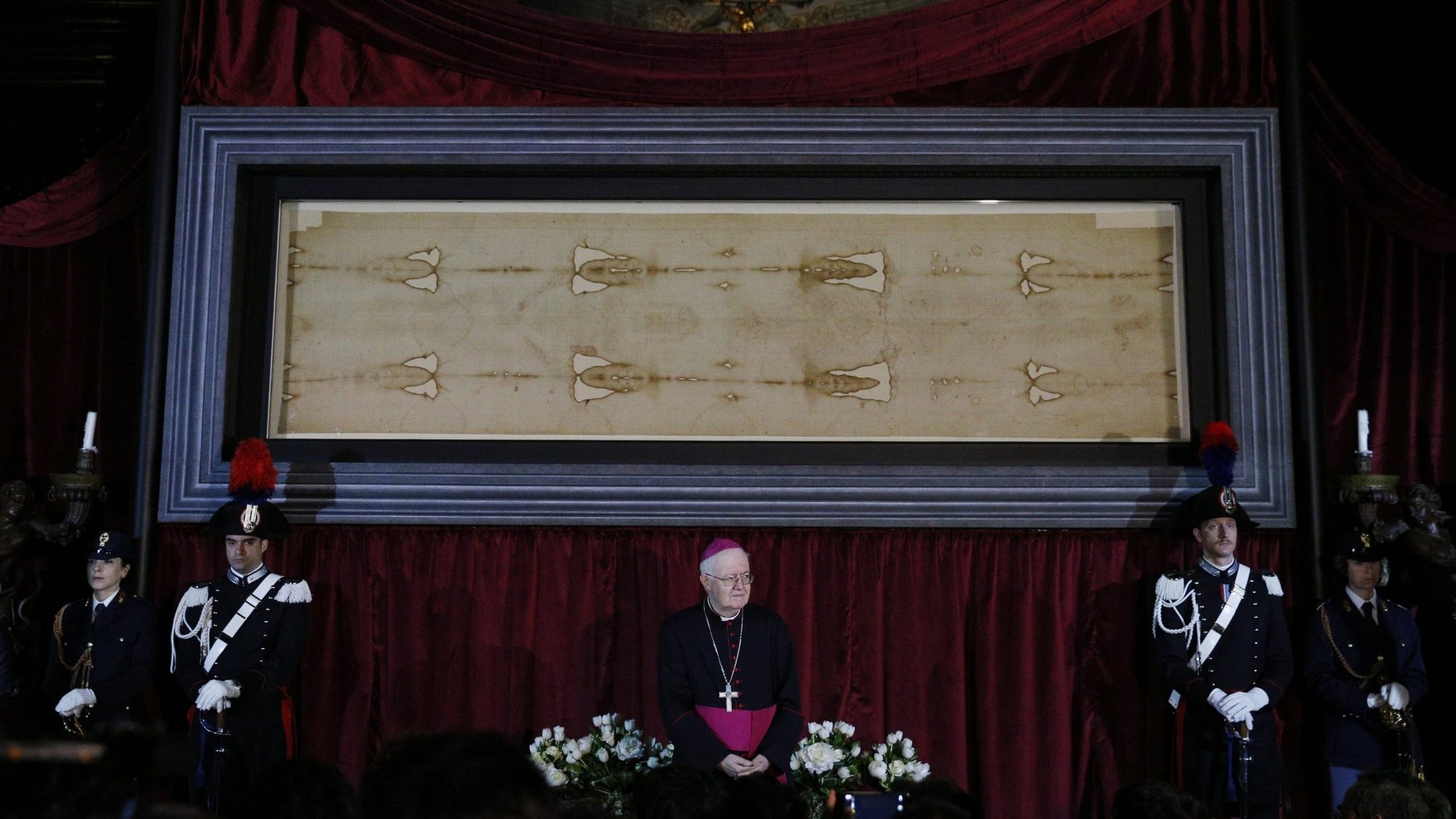 Archbishop Cesare Nosiglia of Turin, Italy, has announced a special live-stream exposition of the Shroud of Turin on Holy Saturday, April 11, at 5 p.m. local time in Turin. Archbishop Nosiglia said he had received "thousands and thousands" of messages asking for the shroud's display as Italy and the world battle the coronavirus. Archbishop Nosiglia is pictured in front of the shroud in the Cathedral of St. John the Baptist in Turin in this April 18, 2015, file photo. (CNS photo/Paul Haring)
