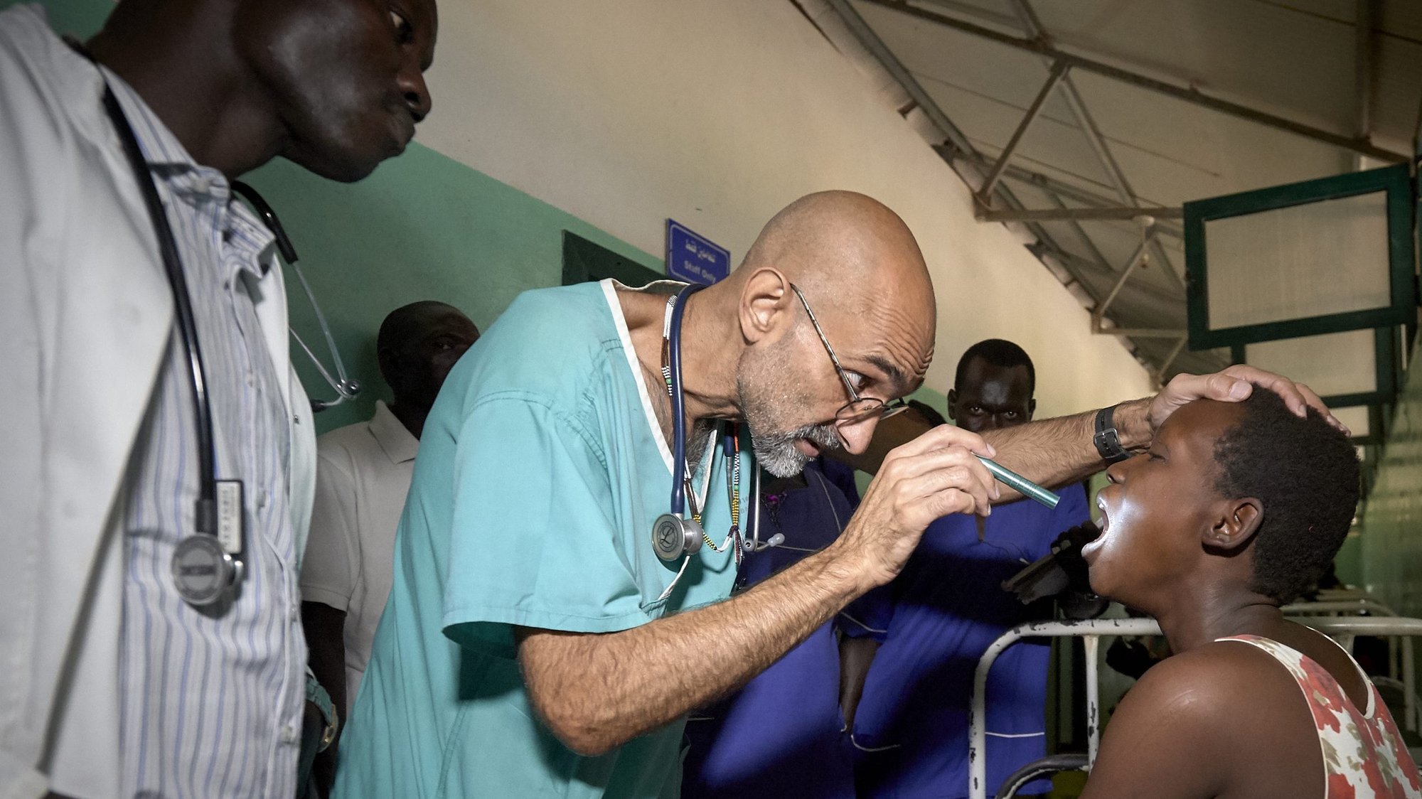 Dr. Tom Catena, a Catholic lay missionary from the United States, examines a patient during rounds at the Mother of Mercy Hospital in Gidel, a village in the Nuba Mountains of Sudan. Pope Francis established an emergency fund to help communities in the Catholic Church's mission territories affected by the 2020 coronavirus pandemic. (CNS photo/Paul Jeffrey)