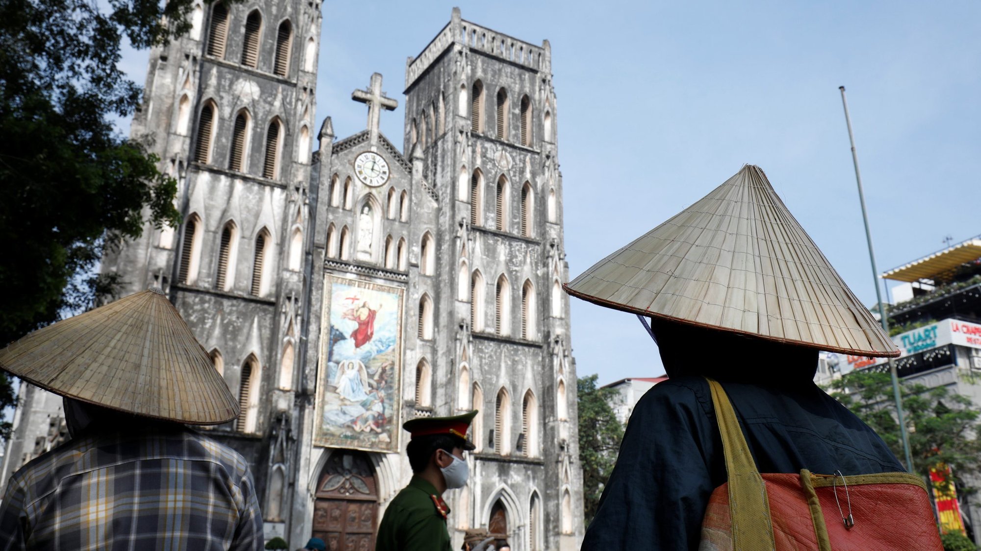 People wait to receive rice donations in front of St. Joseph's Cathedral in Hanoi, Vietnam, April 27, 2020, during the COVID-19 pandemic. (CNS photo/Kham, Reuters)