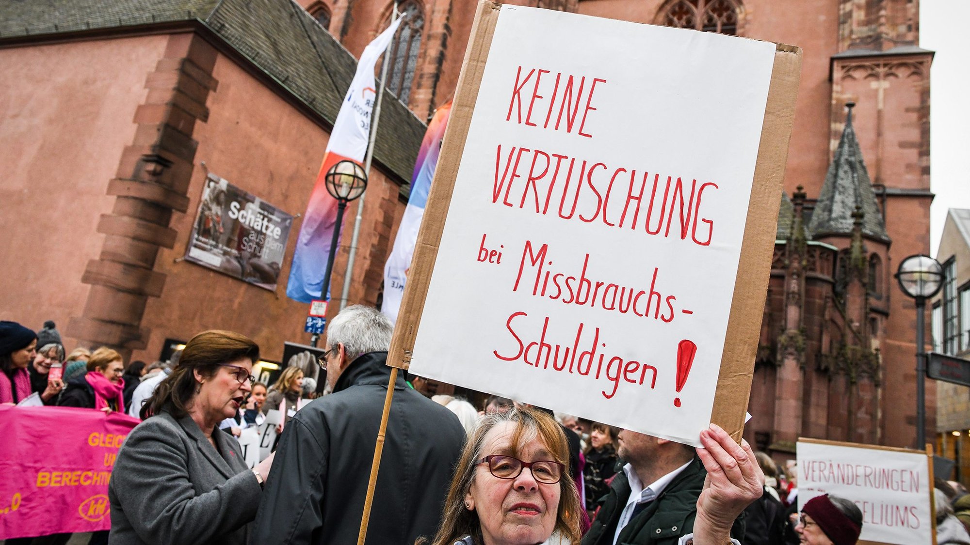A woman near the cathedral in Frankfurt, Germany, holds a sign Jan. 30, 2020, that reads, "No coverup for those guilty of abuse!" (CNS photo/Harald Oppitz, KNA)