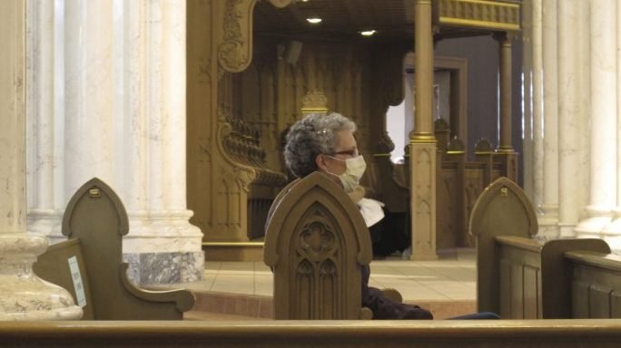 A congregant wears a face mask before mass at the Cathedral of St. Helena in Helena, Mont., Sunday, April 26, 2020. Church services resumed in Montana as the state began to ease restrictions meant to stop the spread of the coronavirus. (Matt Volz/AP via Crux)
