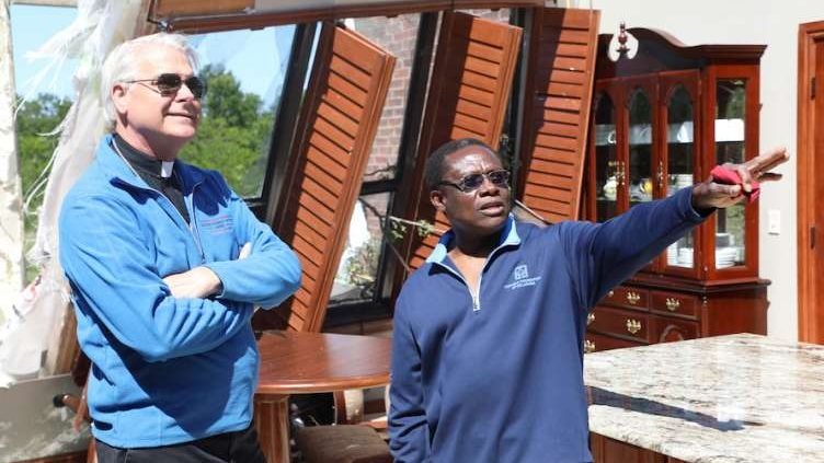 Archbishop Paul Coakley and Fr. Oby Zummas inspect damage at Holy Cross Catholic Church. (Diane Clay/Sooner Catholic)