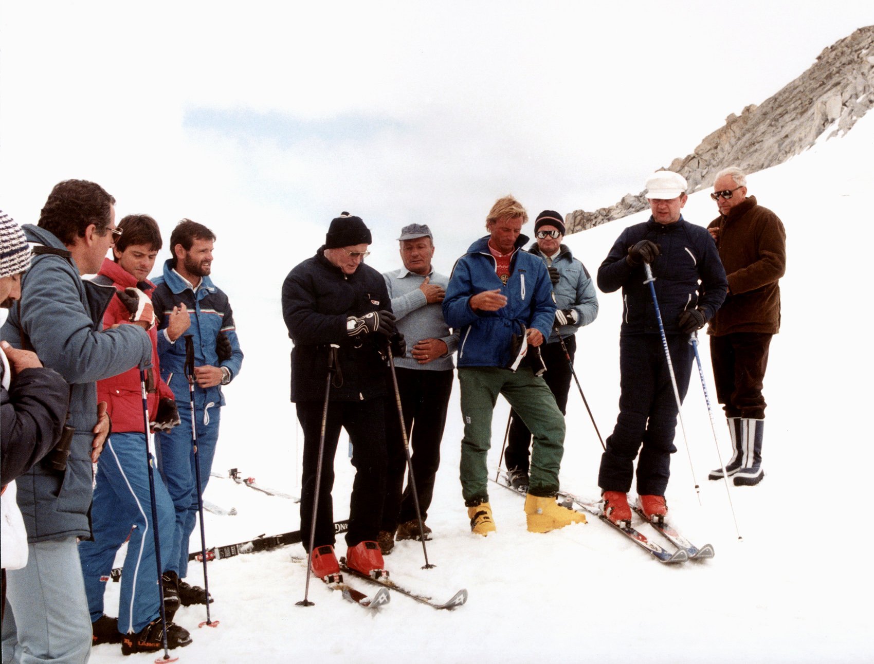 Pope John Paul II, in a black ski jacket and hat, prays with a group of skiers before heading down a slope in Italy in 1984. (Catholic News Service/Arturo Mari, L'Osservatore Romano)