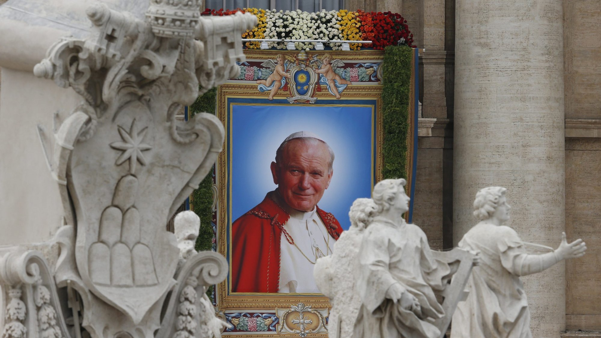 A banner depicting St. John Paul II hangs from the facade of St. Peter's Basilica at the Vatican April 27. (CNS photo/Paul Haring) (April 27, 2014)
