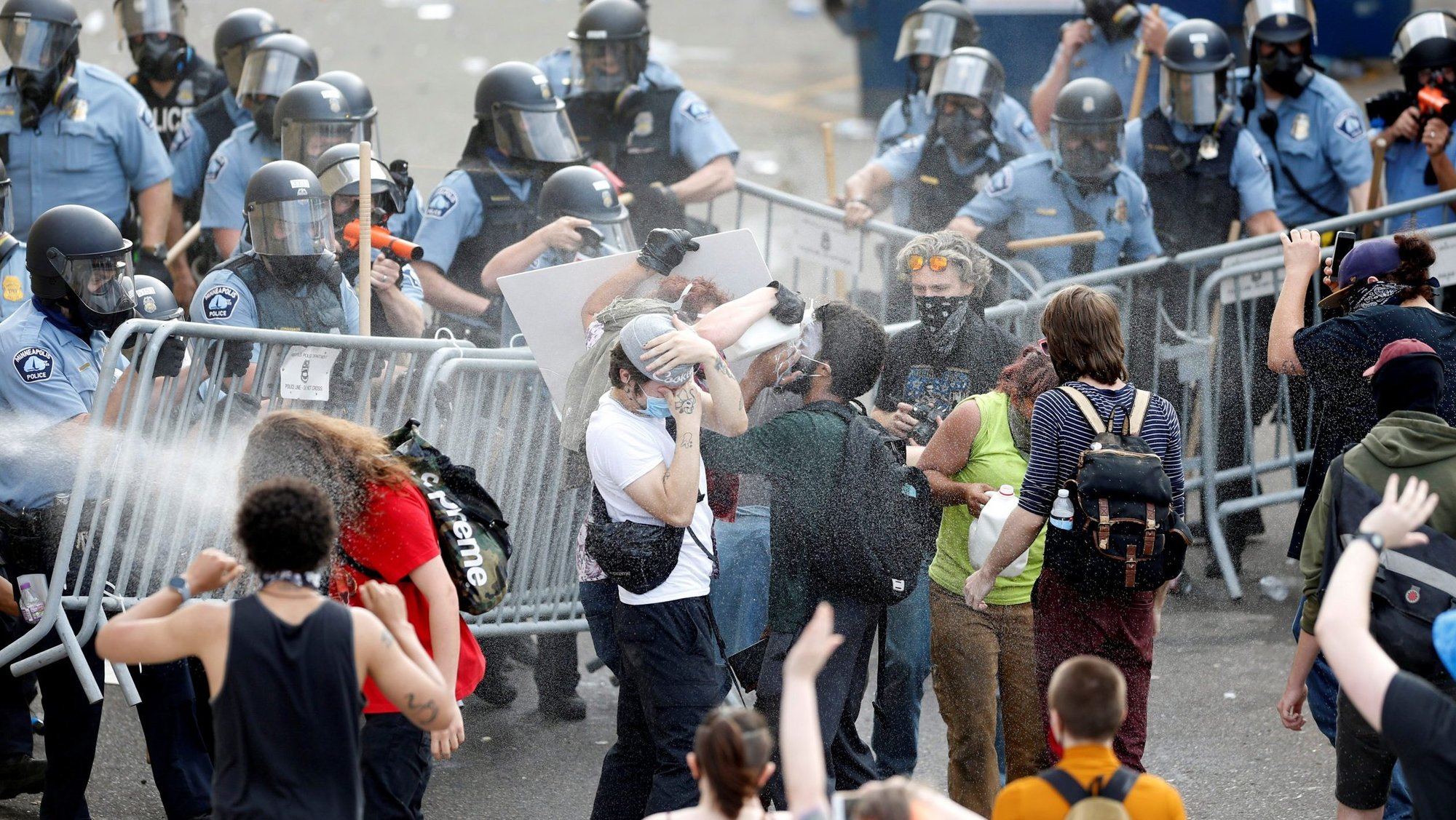 Police in Minneapolis spray mace at protesters to break up a gathering near the Minneapolis Police Third Precinct May 27, 2020. Two days earlier George Floyd, an unarmed black man, was pinned down by a police officer kneeling on his neck before later dying in the hospital May 25. (CNS photo/Eric Miller, Reuters)
