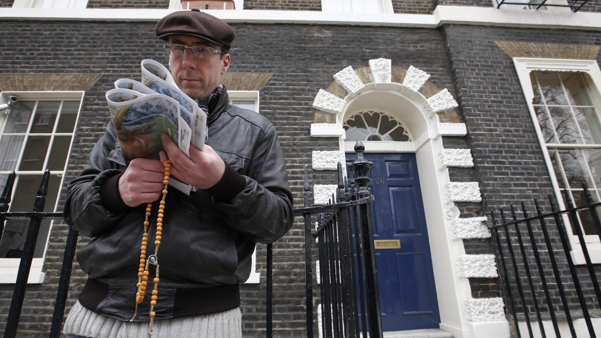 A pro-life activist holds a rosary outside an abortion clinic in 2012 in London. (CNS photo/Andrew Winning, Reuters)