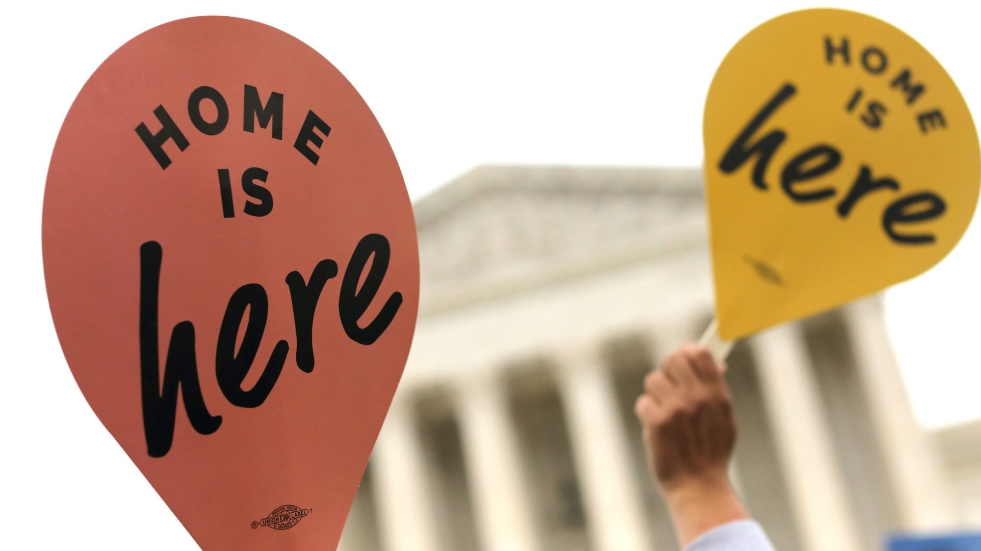 DACA demonstrators hold signs outside the U.S. Supreme Court in Washington Nov. 12, 2019, as justices hear oral arguments in a legal challenge to the Trump administration's bid to end the Deferred Action for Childhood Arrivals. (CNS photo/Jonathan Ernst, Reuters)