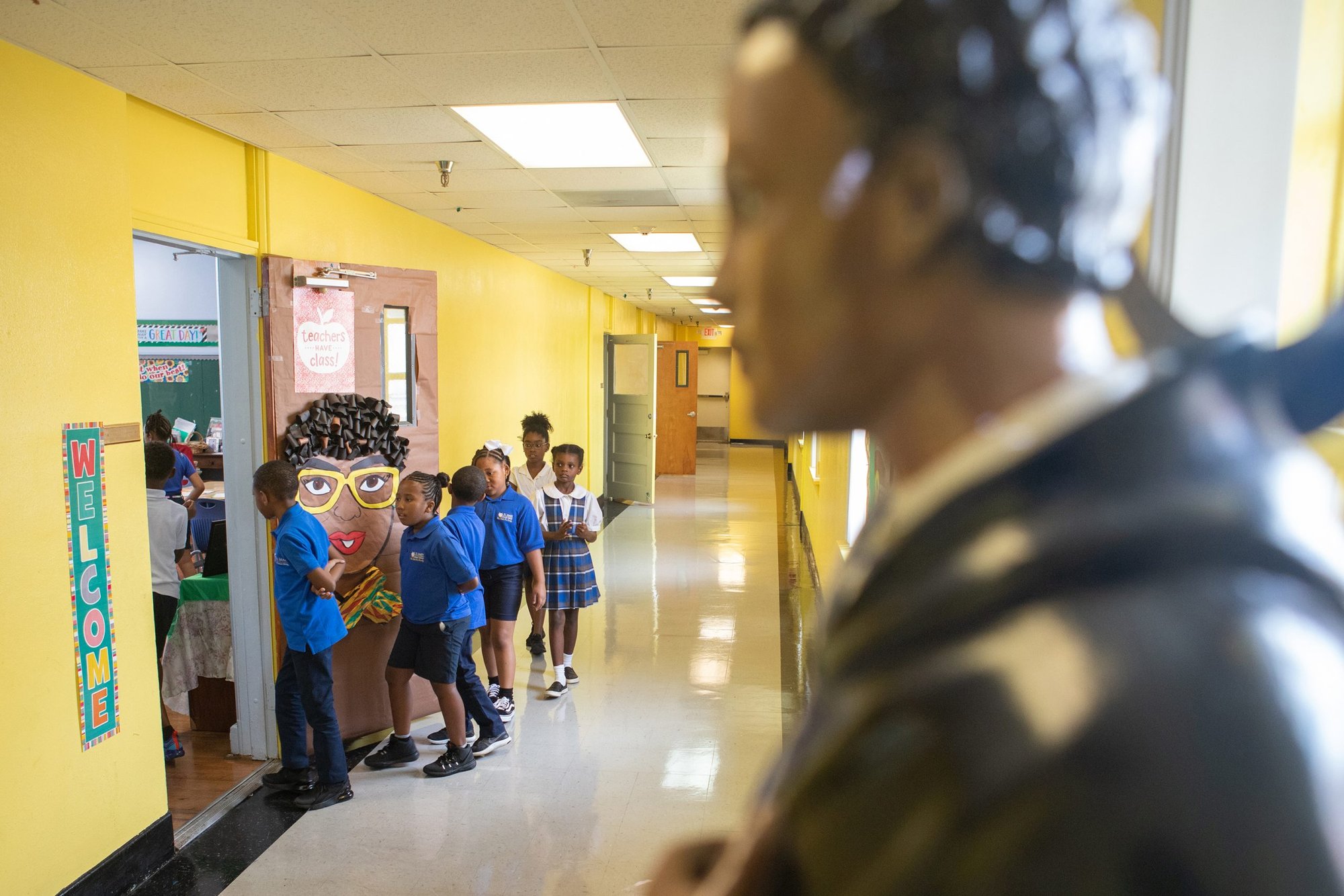Students at St. Mary of the Purification Montessori School in Houston walk by a statue of St. Martin de Porres in this 2019 photo. U.S. Catholic schools are moving to avert fiscal disaster amid the coronavirus pandemic. (CNS photo/James Ramos, Texas Catholic Herald)