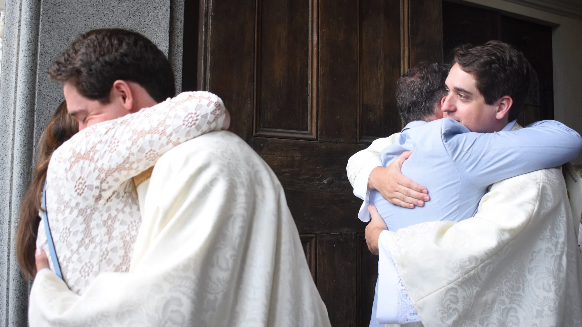 Father Connor Plessala, left, and Father Peyton Plessala of Mobile, Ala., hug their parents, Dr. Deneen Plessala and Dr. Kirby Plessala, outside the Cathedral-Basilica of the Immaculate Conception following their ordination to the priesthood May 30, 2020. (CNS photo/Rob Herbst, The Catholic Week)