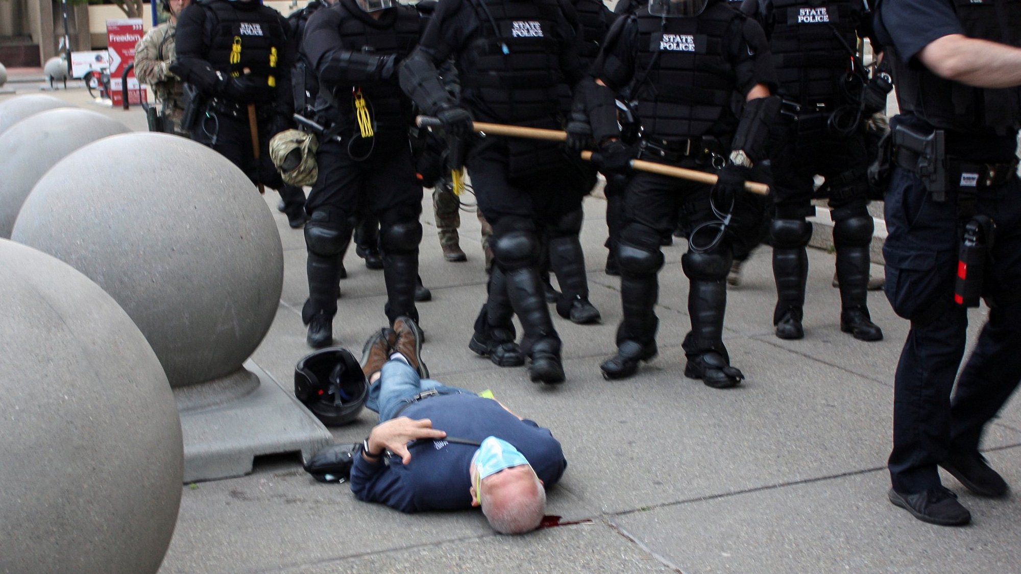 Martin Gugino, a 75-year-old protester and longtime Catholic Worker peace activist, lies on the ground after he was shoved by two Buffalo police officers June 4, 2020, during a protest against police violence against minorities. (CNS photo/Jamie Quinn, Reuters)