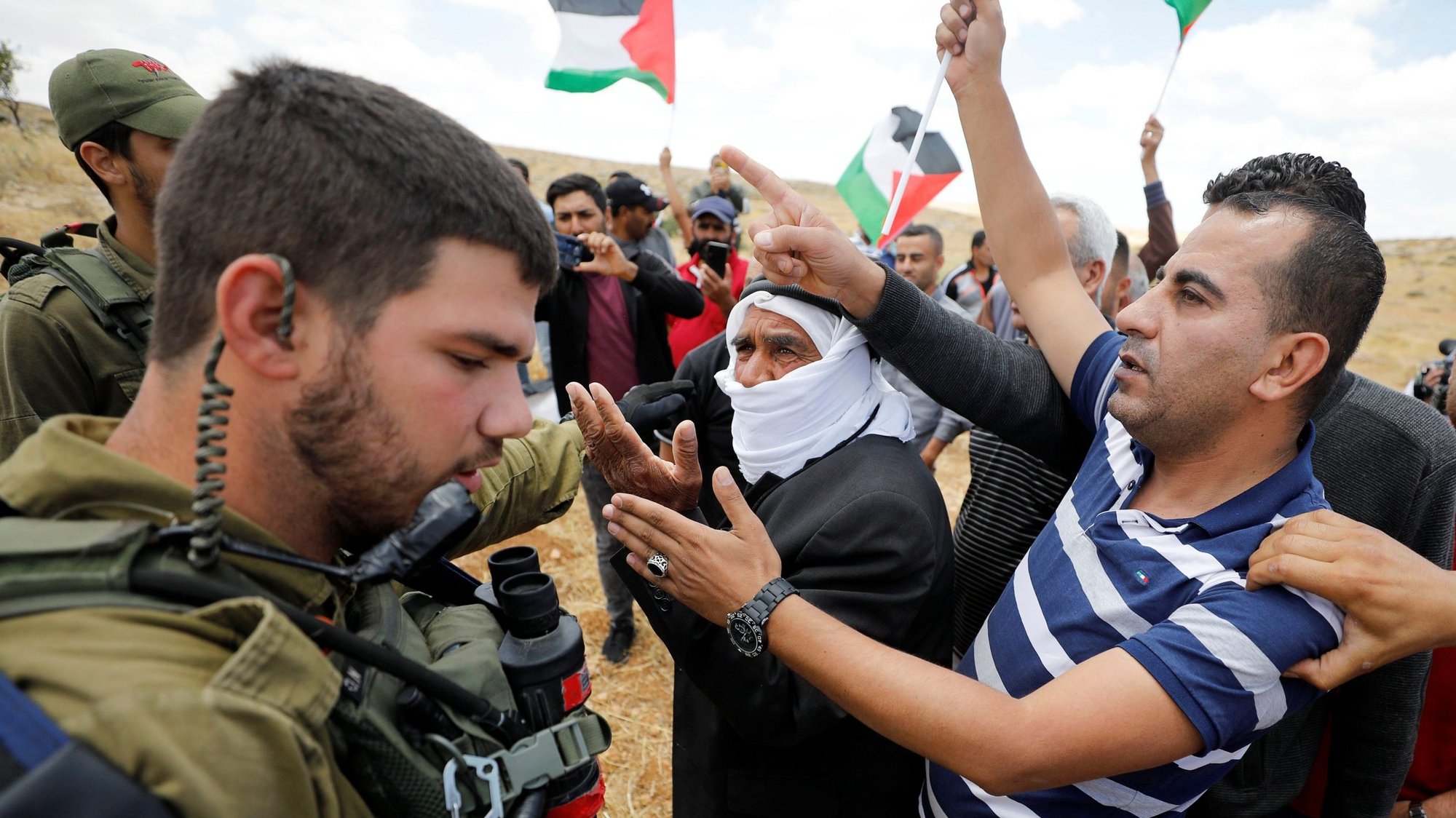 Palestinians argue with Israeli soldiers during a June 19, 2020, protest near Hebron, West Bank. Three retired Christian leaders released a new statement amid growing tensions over Israel's U.S.-sanctioned bid to officially annex parts of the West Bank, including the Jordan Valley. (CNS photo/Mussa Qawasma, Reuters)