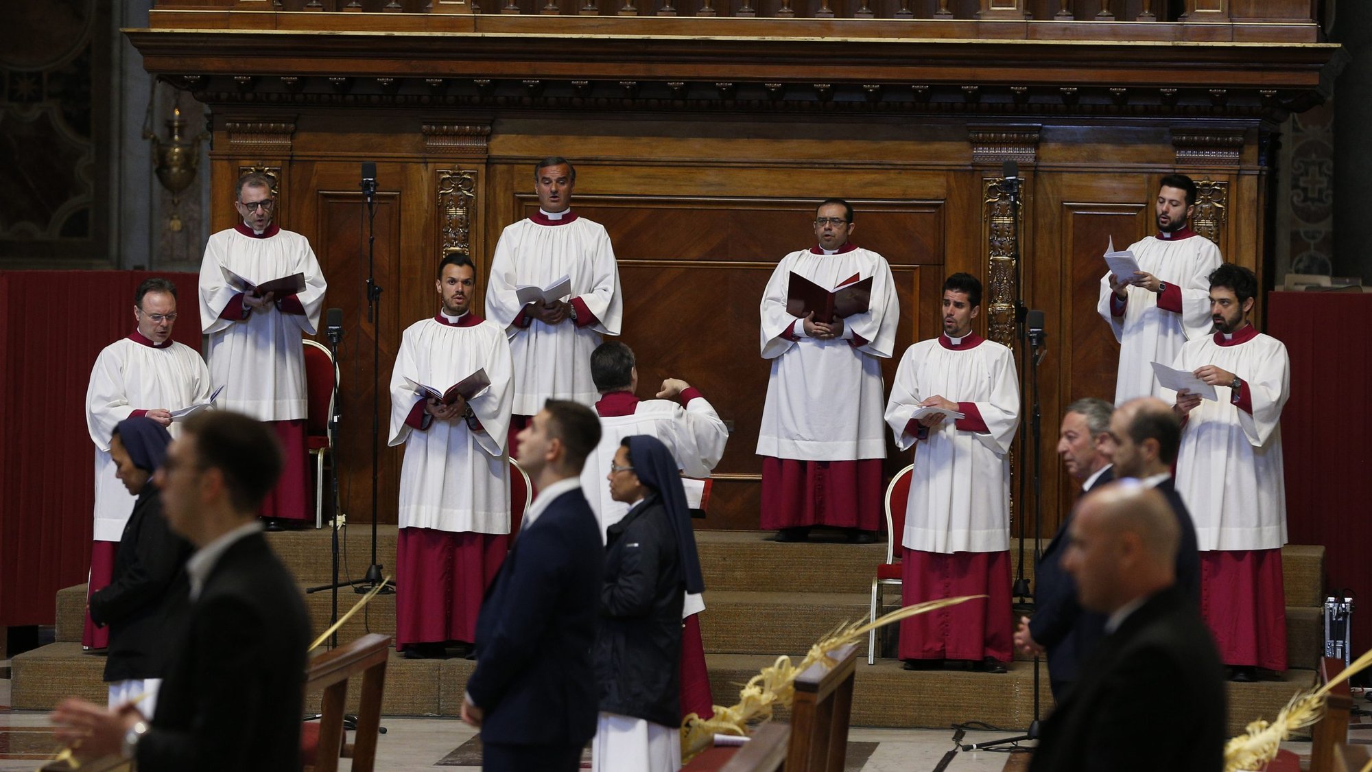 A file photo shows some members of the Sistine Chapel Choir singing while maintaining social distancing as Pope Francis celebrates Palm Sunday Mass in St. Peter's Basilica at the Vatican. The Mass was celebrated without the presence of the public during the COVID-19 pandemic. (CNS photo/Paul Haring)