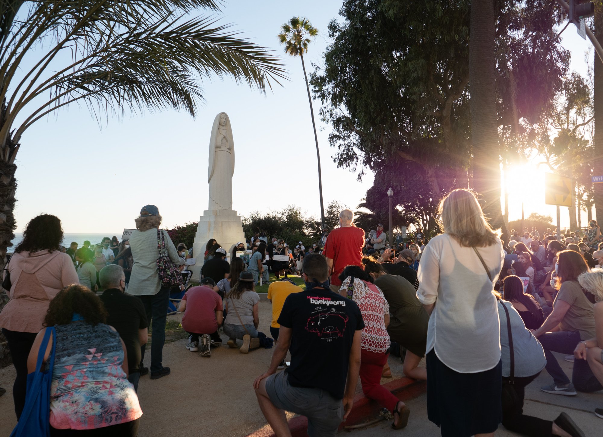 People knelt for 8 minutes and 46 seconds in silence around the statue of St. Monica during a special prayer walk and vigil to end racial inequality on June 9, the day of George Floyd's funeral. (JohnMichael Filippone)