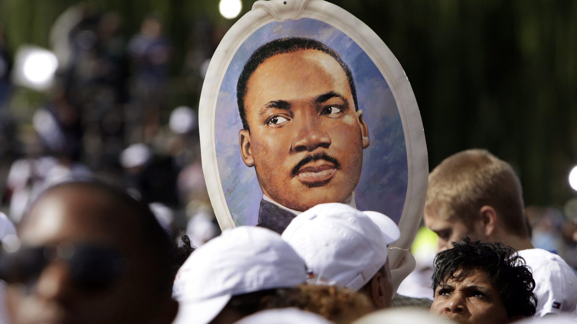 A woman holds a portrait of the Rev. Martin Luther King Jr. during the 2011 dedication of the King memorial at the National Mall in Washington. (CNS photo/Yuri Gripas, Reuters)