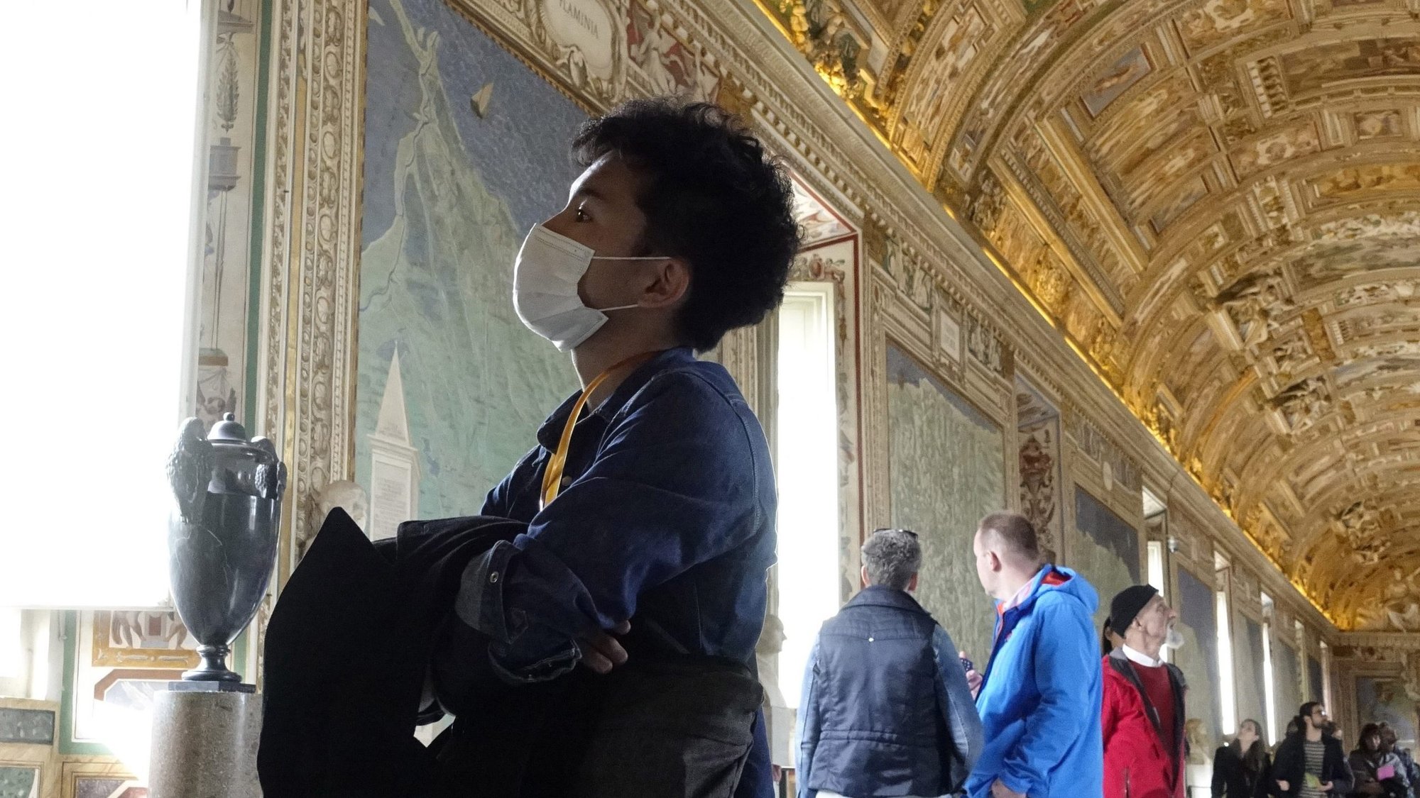 A visitor wears a mask for protection from the coronavirus while touring the Vatican Museums in February. With many countries barred from traveling due to an increasing number of coronavirus infections, online virtual tours have become a way for would-be tourists to take in the breathtaking masterpieces on display in the museums' hallowed halls. (CNS photo/Paul Haring)