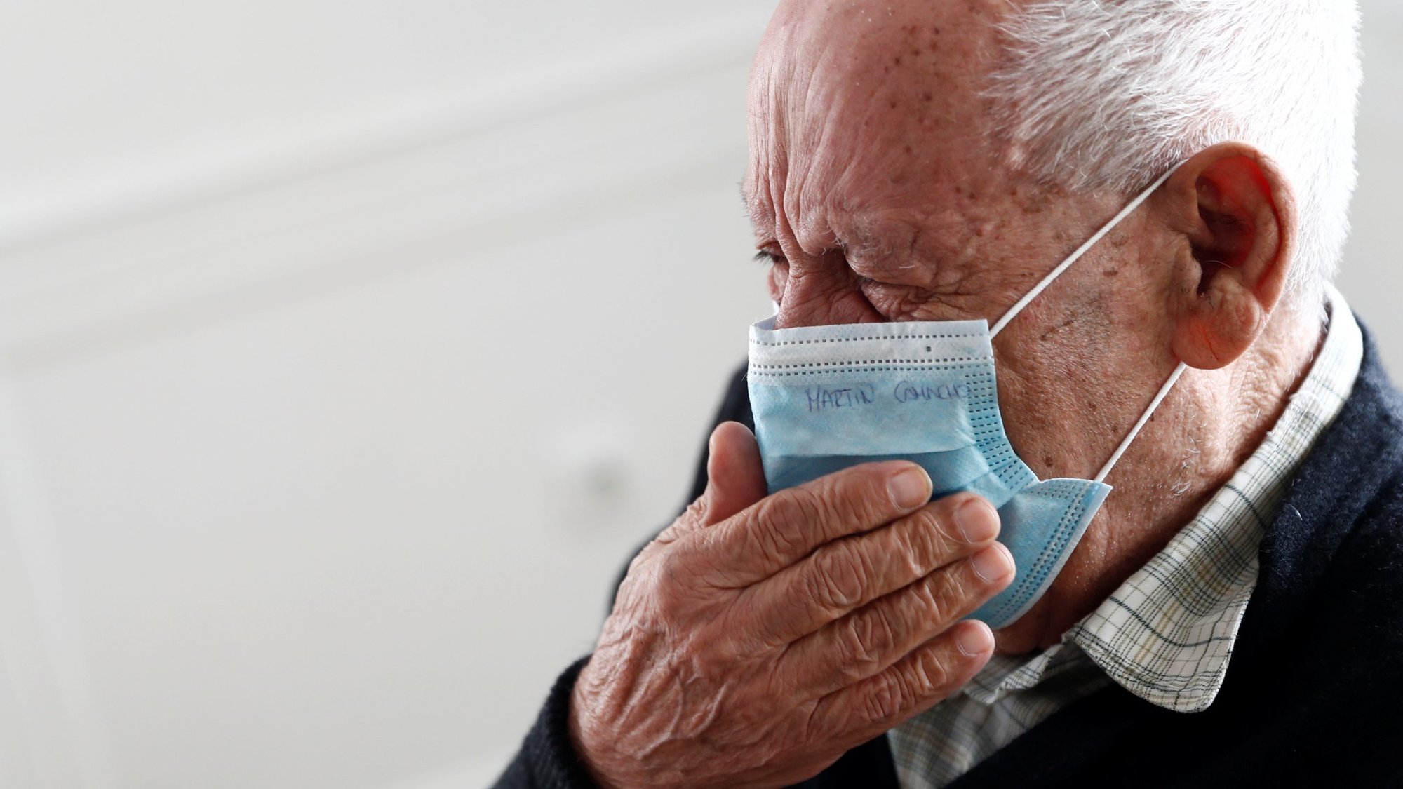 Martin Camacho becomes emotional as his wife is allowed to visit him in a Madrid nursing home in early June, the first day family visits resumed during the COVID-19 pandemic. (CNS photo/Susana Vera, Reuters)