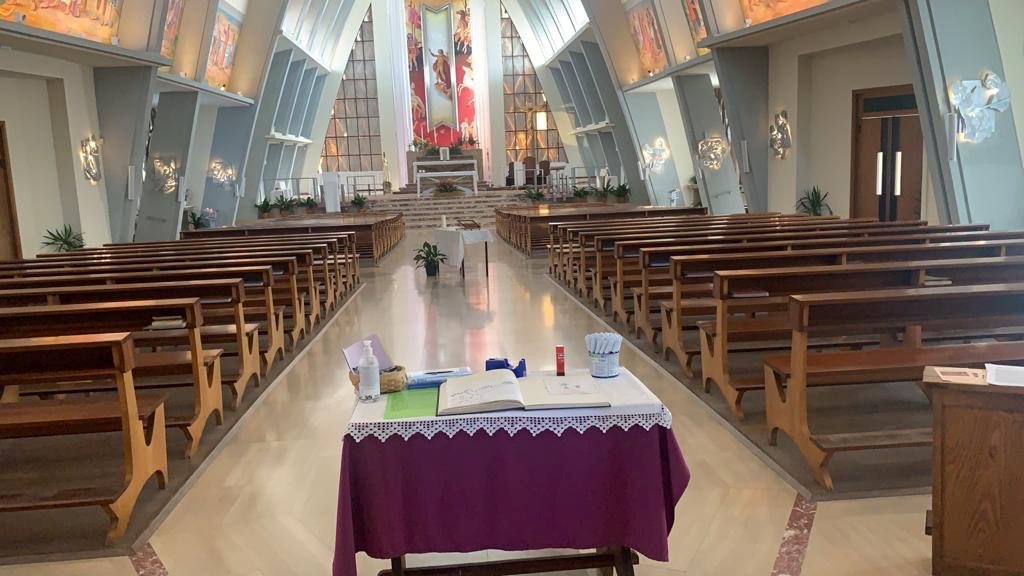 A book and hand sanitizer are seen at the entry way of the San Polo church in Brescia, Italy, in this July 9, 2020, photo. Italian bishops are being asked to consider ways to reach parishioners for fall programs during phase three of pandemic reopening. (CNS photo/Marco Mori, Reuters)