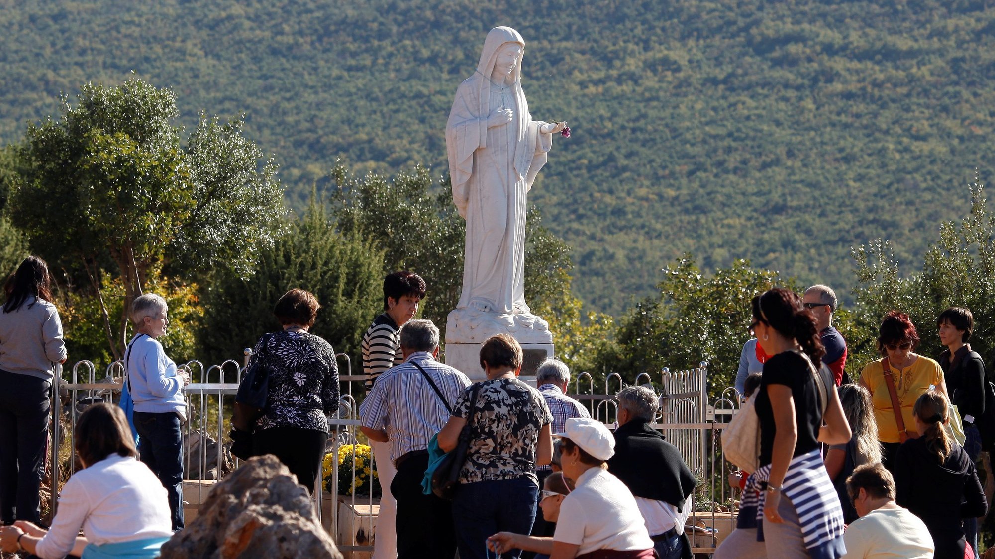 Pilgrims are pictured in a file photo surrounding a statue of Mary on Apparition Hill in Medjugorje, Bosnia-Herzegovina. (CNS photo/Matko Biljak, Reuters)