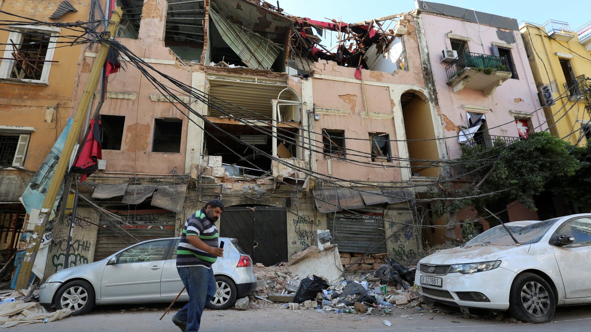 A man walks past rubble of damaged buildings Aug. 7, 2020, following blasts at Beirut's port area. Three days after a massive explosion ripped through Lebanons capital city, the death toll has climbed to more than 150, while the total number of injured soared to at least 5,000, according to data released by Lebanon's health ministry. (CNS photo/Aziz Taher, Reuters)