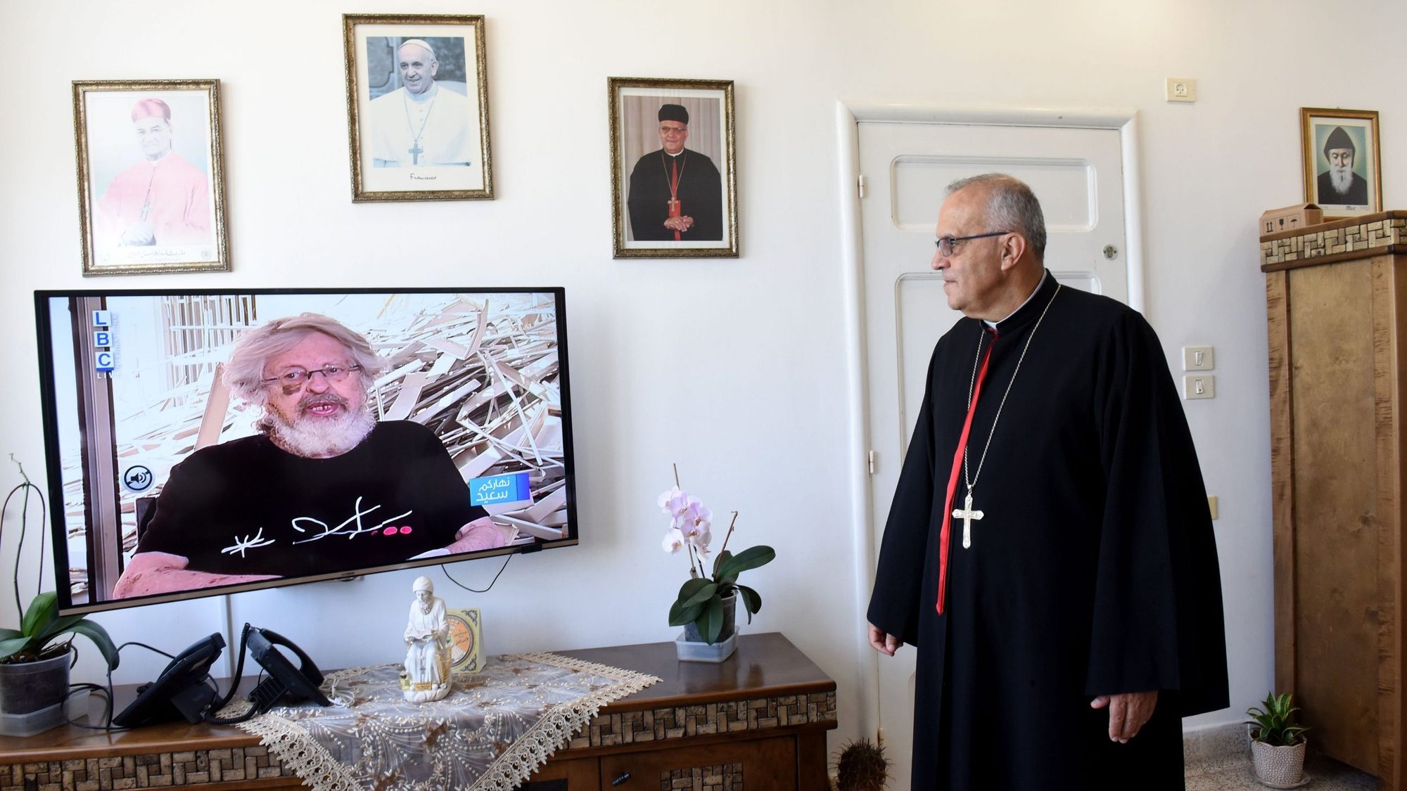 Maronite Archbishop Moussa El-Hage of Haifa, Israel, watches Lebanese television in his residence Aug. 12, 2020. (CNS photo/Debbie Hill)