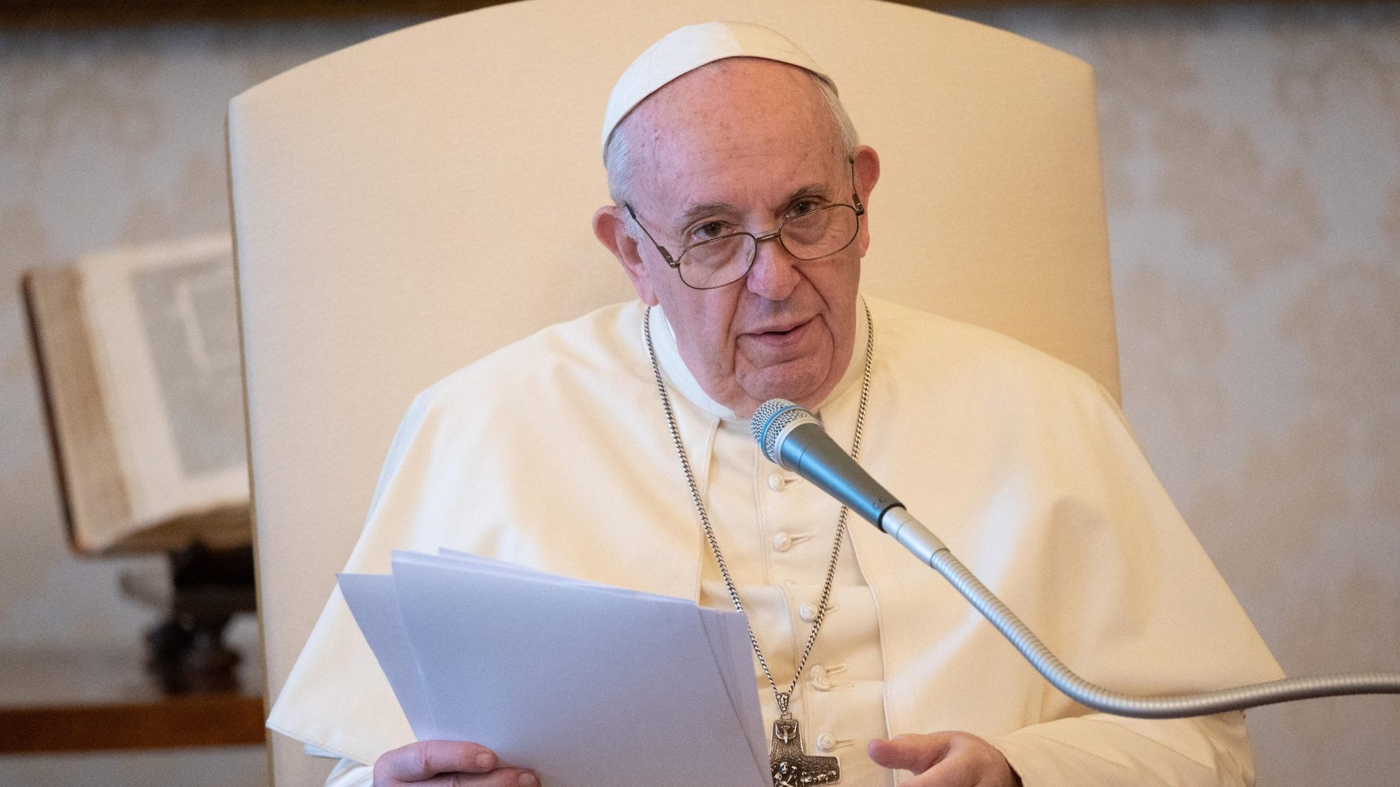 Pope Francis leads his general audience in the library of the Apostolic Palace at the Vatican Aug. 26, 2020. Christians cannot stand idly by and watch as milions of people are deprived of their basic needs because of greed, the pope said. (CNS photo/Vatican Media)