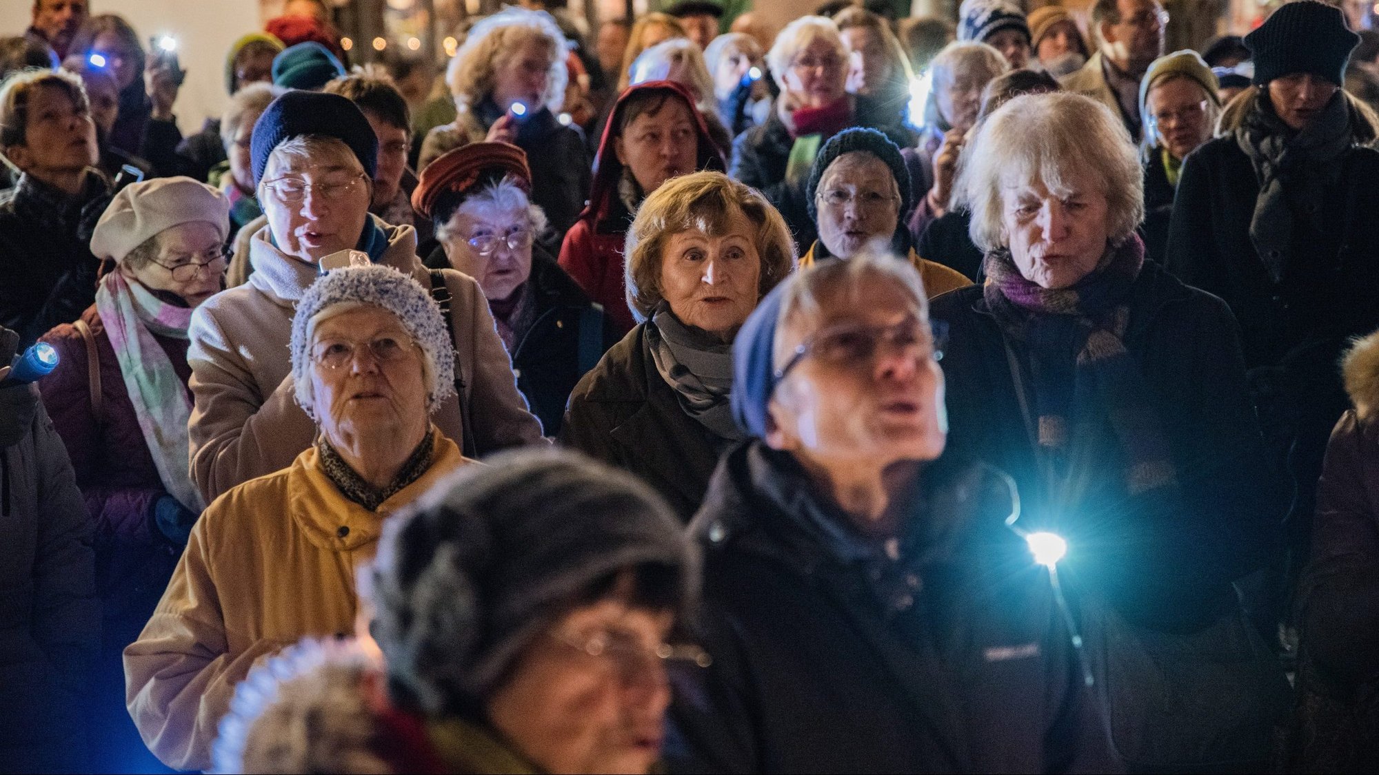 Women shine flashlights on the main entrance to the Imperial Cathedral in Frankfurt, Germany, during a 2018 protest against sexual abuse in the Catholic Church in their country. The act was to symbolically bring light into the darkness of abuse. (CNS photo/Bert Bostelmann, KNA)