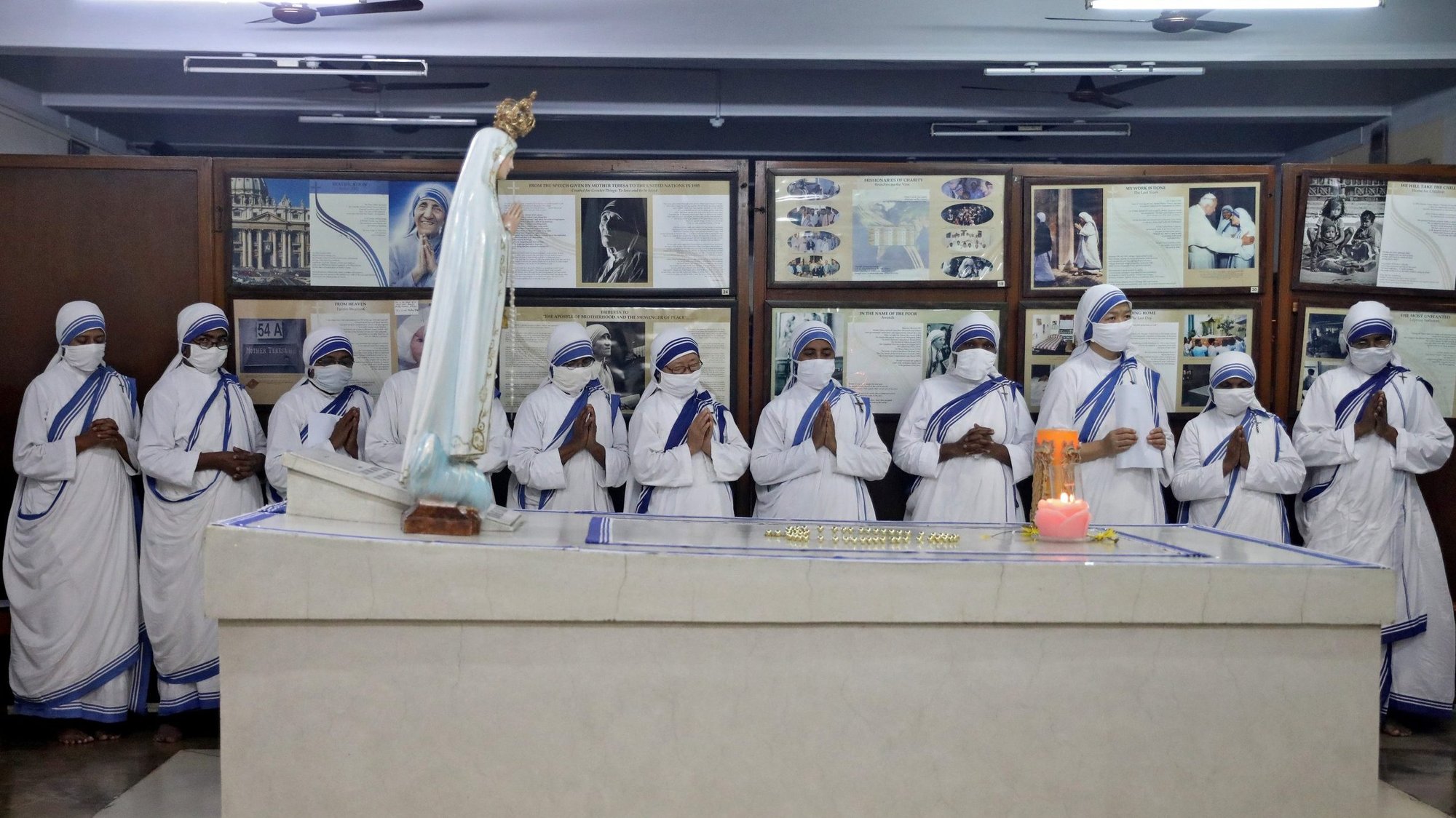 Members of the Missionaries of Charity, wearing protective masks, pray at the tomb of St. Teresa of Kolkata in Kolkata, India, Aug. 26, 2020, to mark her 110th birthday. (CNS photo/Rupak De Chowdhuri, Reuters)
