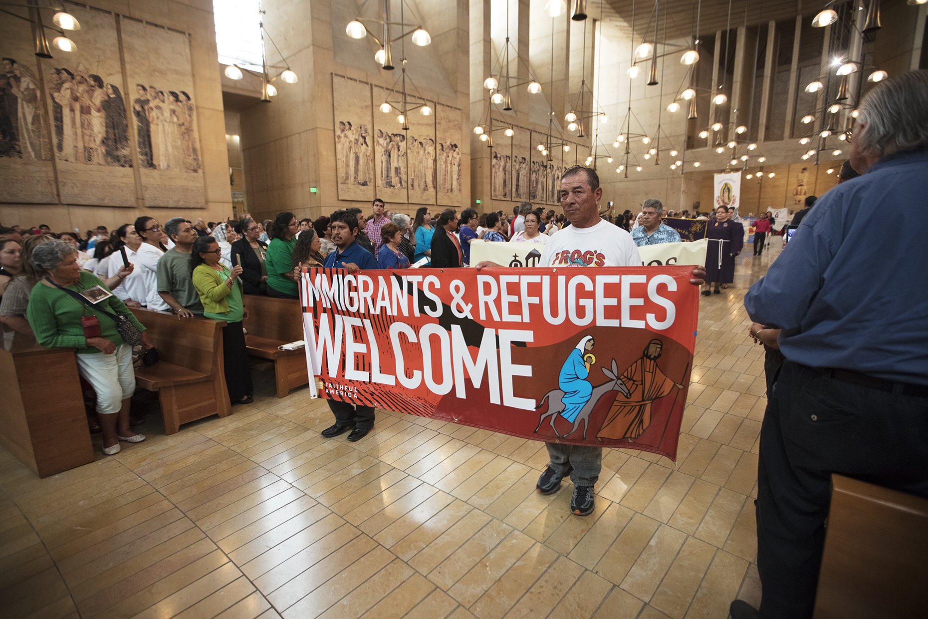 A banner is carried into the Cathedral of Our Lady of the Angels during the annual Mass in Recognition of all Immigrants on June 24, 2018. (Victor Alemán)