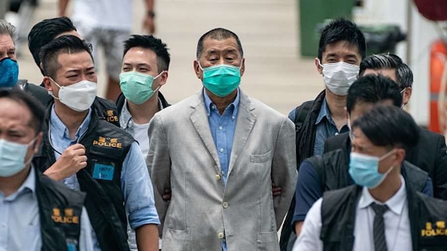 Hong Kong media tycoon and Apple Daily founder Jimmy Lai (C) is escorted by the police after his Aug. 10 arrest. (Anthony Kwan/Getty Images via CNA)