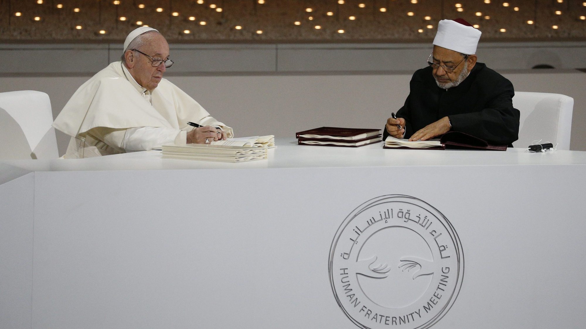 Pope Francis and Sheikh Ahmad el-Tayeb, grand imam of Egypt's al-Azhar mosque and university, sign documents during an interreligious meeting at the Founder's Memorial in Abu Dhabi, United Arab Emirates, Feb. 4, 2019. The document was on "human fraternity" and improving Christian-Muslim relations. (CNS photo/Paul Haring)