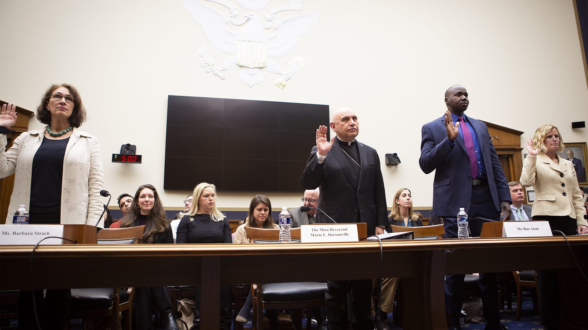 Auxiliary Bishop Mario E. Dorsonville of Washington takes an oath prior to addressing the House Judiciary Subcommittee on Immigration and Citizenship in Washington Feb. 27, 2020. Also pictured are Barbara Strack, advisory member for Church World Service Immigration and Refugee Program and former chief of the refugee affairs division for U.S. Citizenship and Immigration Services; Biar Atem, a Nevada delegate to the Refugee Congress and a member of its board of directors; and Lora Ries, senior research fellow in homeland security at the Heritage Foundation. (CNS photo/Tyler Orsburn)