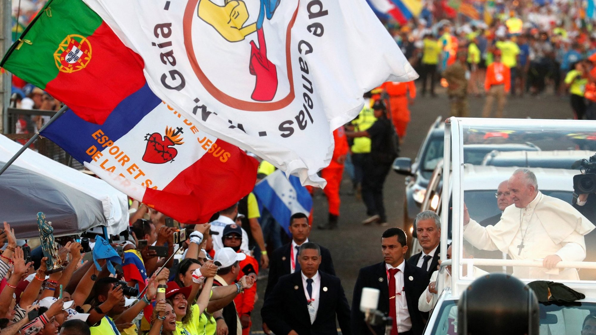 A Portuguese flag is seen near Pope Francis as he greets the crowd before celebrating Mass for World Youth Day pilgrims at St. John Paul II Field in Panama City Jan. 27, 2019. World Youth Day in Lisbon, Portugal, will be pushed back until August 2023, the Vatican announced. (CNS photo/Alessandro Bianchi, Reuters)