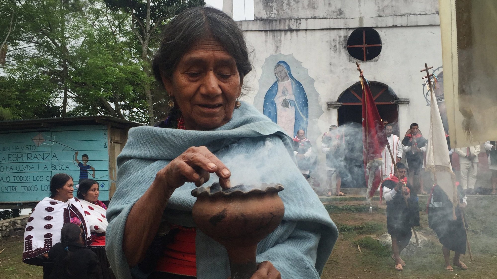 An Indigenous woman from the Tzotzil tribe is pictured in a file photo burning incense outside a church in Acteal, Mexico. The hamlet was the scene of a 1997 massacre that claimed the lives of 45 Indigenous residents. (CNS photo/David Agren)