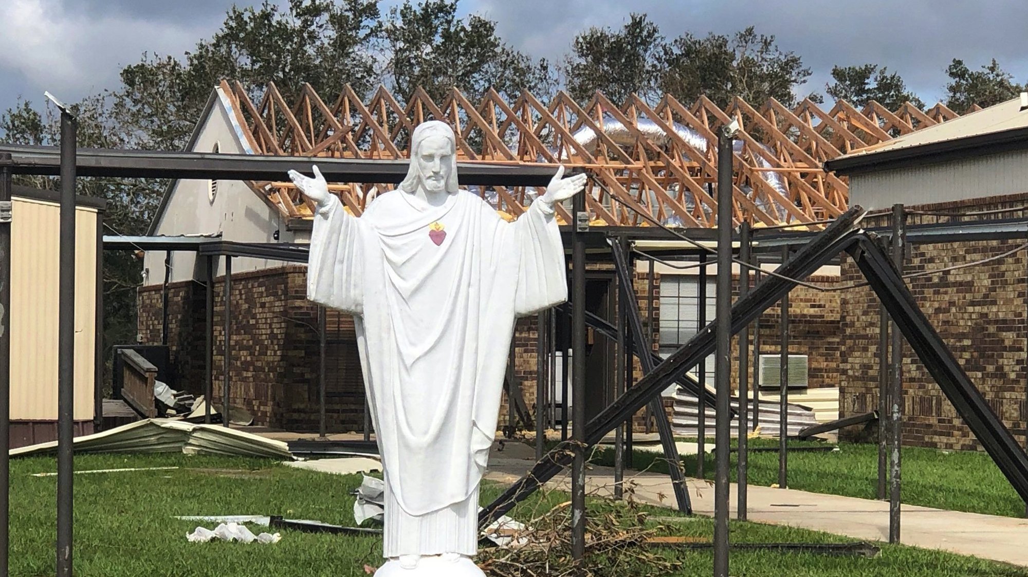A statue of the Sacred Heart of Jesus is seen outside of St. Pius X Church in Ragley, La., Sept. 1, 2020, with signs of damage from Hurricane Laura. Archbishop José H. Gomez of Los Angeles, president of the U.S. Conference of Catholic Bishops, requested Sept. 3 that bishops across the country consider taking up a voluntary special collection for the humanitarian, long-term recovery and church needs arising from the increasing number of natural disasters in the United States. (CNS photo/courtesy Father Jeffrey Starkovich, St. Pius X Church)