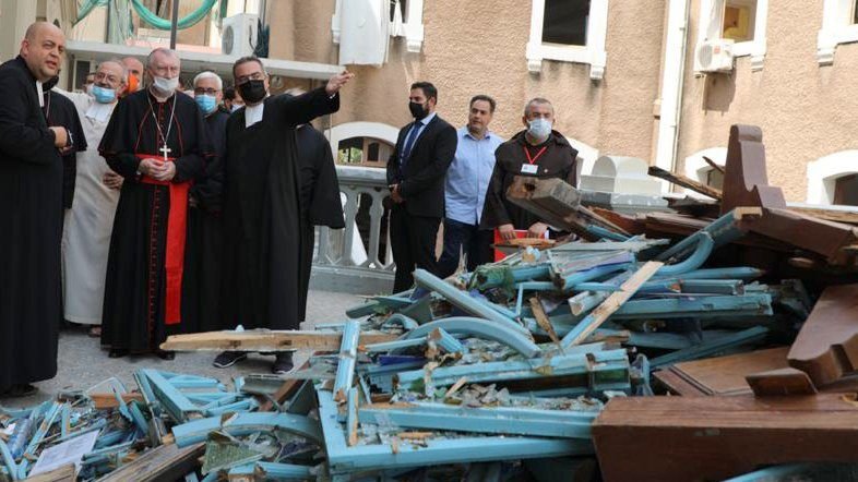 Cardinal Pietro Parolin, Vatican secretary of state, with red sash, views the damage at Sacred Heart School near Beirut's port area Sept. 4, 2020, one month after the city suffered double blasts. (CNS photo/Mychel Akl for Maronite Patriarchate)